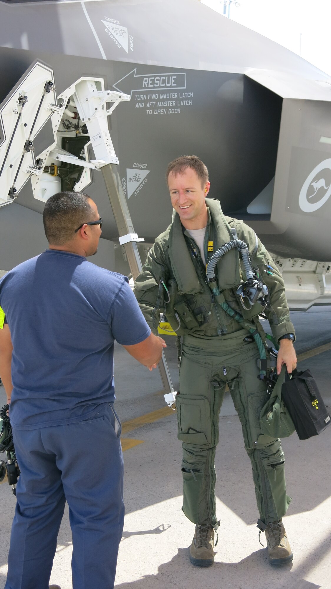 Jorge Salazar, Lockheed Martin Maintenance and attending recovery chief assists Maj. Matt Olson, 62nd FS assistant director of operations.