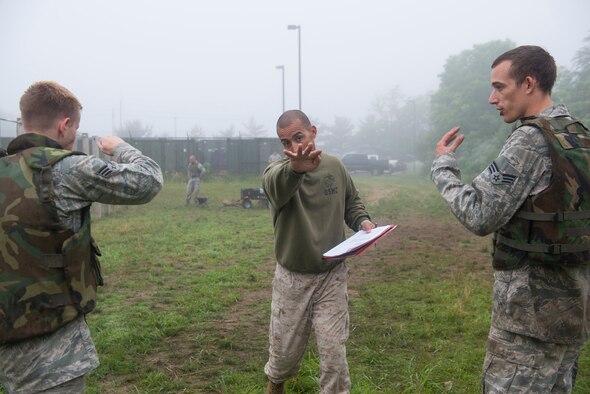 Marine Gunnery Sgt. Lucio Bernabe, Marine Aircraft Group 49 and MCMAP instructor, demonstrates the correct eye gouge movement after a Marine Corps Martial Arts Program tan belt class on Joint Base McGuire-Dix-Lakehurst, N.J. June 16, 2015. Ten Airmen took and passed the course. (U.S. Air Force photo by Airman 1st Class Joshua King/released)