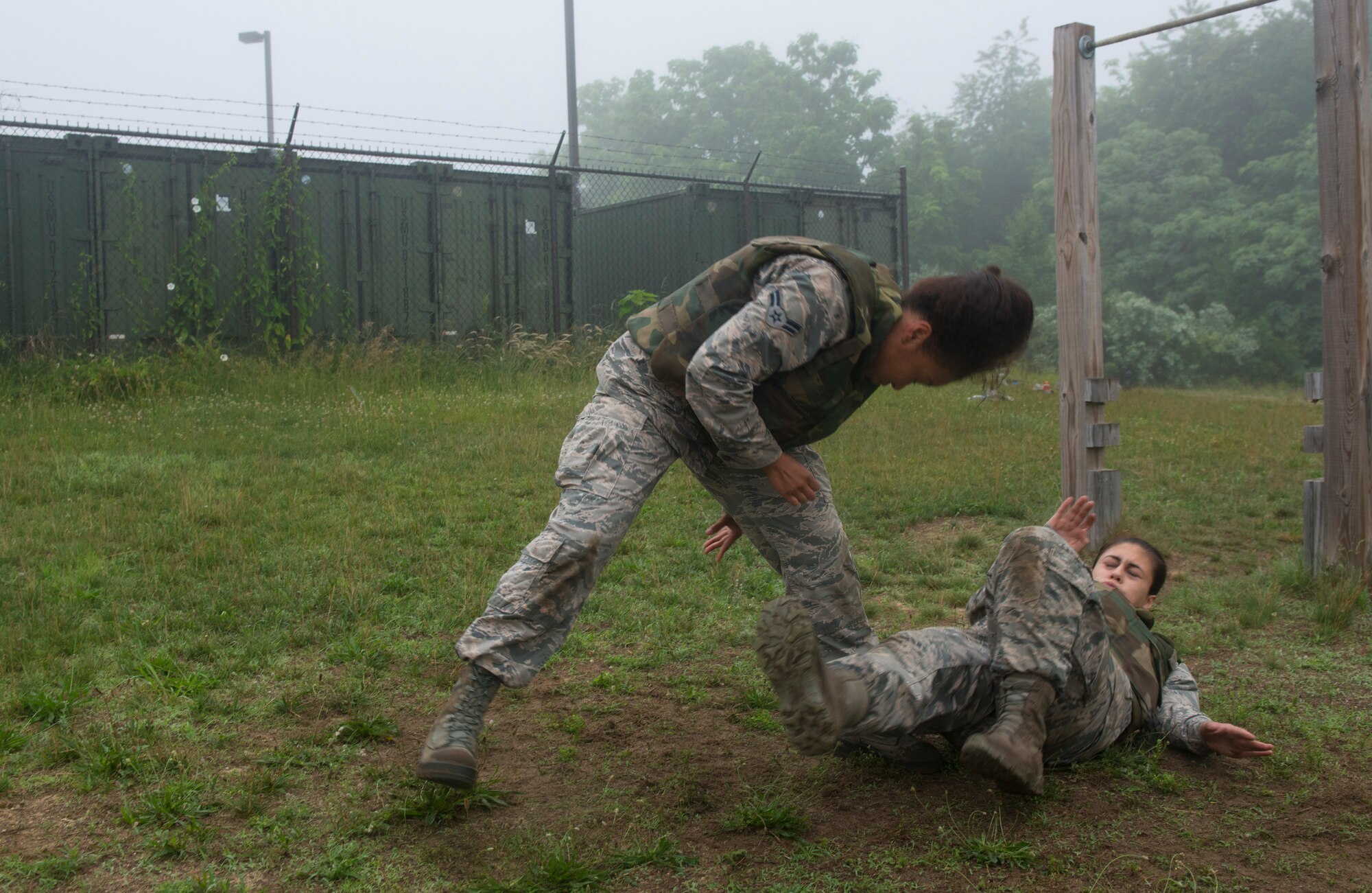 A1C Marshia Wong-Holly, 87th Medical Group mental health clinic medical technician, throws A1C Christine Gonzalez  87th MDG Topa flight patient travel technician, to the ground during her Marine Corps Martial Arts Program tan belt test on Joint Base McGuire-Dix-Lakehurst, N.J. June 16, 2015. Ten Airmen took and passed the course. (U.S. Air Force photo by Airman 1st Class Joshua King/released)