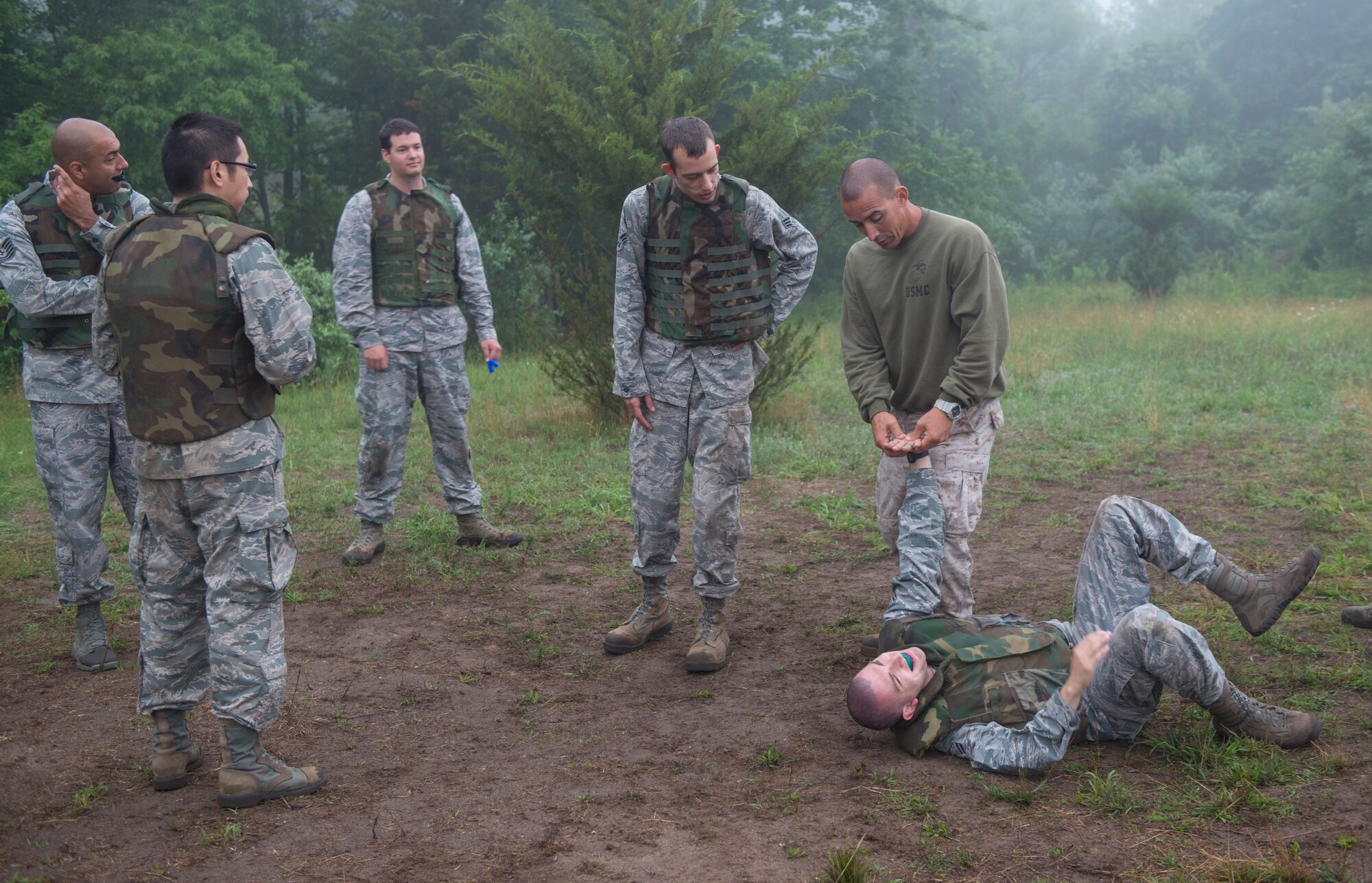 Marine Gunnery Sgt. Lucio Bernabe, Marine Aircraft Group 49 and MCMAP instructor, demonstrates the final part of a wrist take down during a Marine Corps Martial Arts Program tan belt class for Airmen on Joint Base McGuire-Dix-Lakehurst, N.J. June 16, 2015. Ten Airmen took and passed the course. (U.S. Air Force photo by Airman 1st Class Joshua King/released)