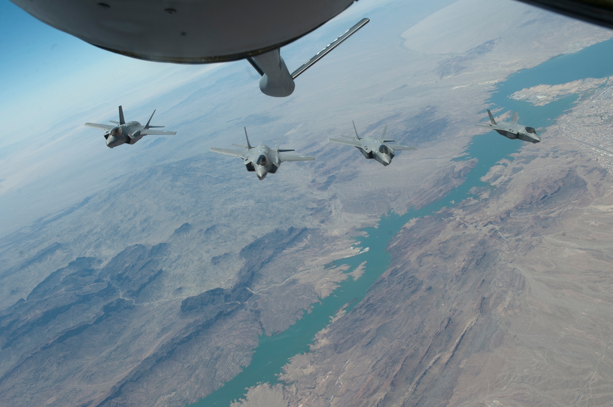 F-35 Lightning IIs from the 61st Fighter Squadron train air-to-air refueling operations with the 161st Air Refueling Wing, June 5, 2015. (U.S. Air Force photo by Staff Sgt. Staci Miller))
