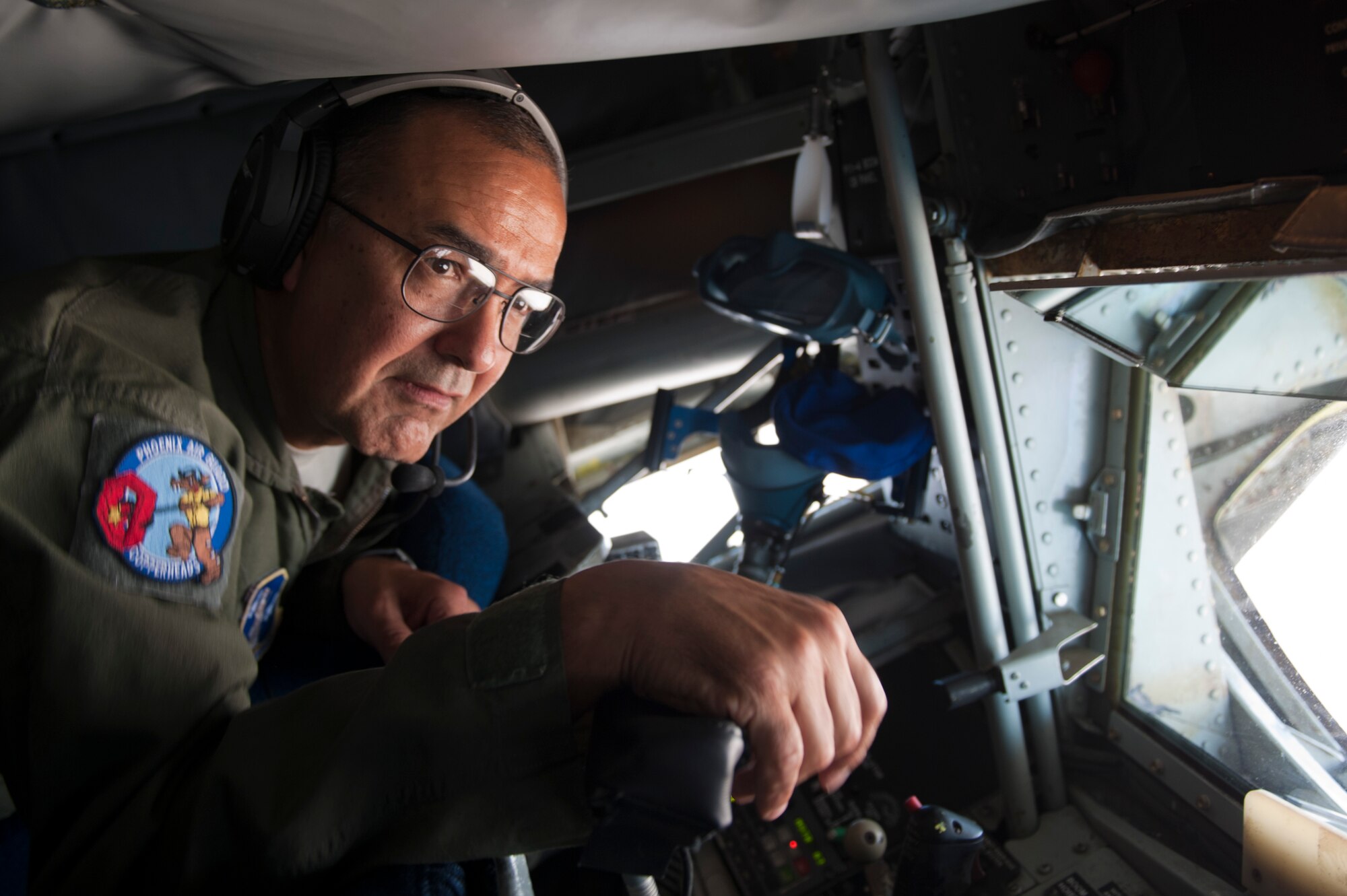 Chief Master Sgt. Carlos Trujillo, 161st Air Refueling Wing boom operator, prepares to refuel 61st Fighter Squadron F-35 Lightning IIs, June 5, 2015. Air-to-air refueling allows pilots to extend the combat radius of their aircraft. (U.S. Air Force photo by Staff Sgt. Staci Miller)