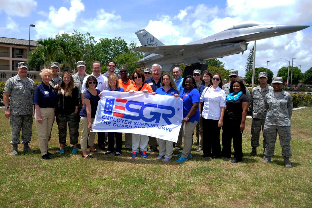 Mission United members pose in front of a static display jet at Homestead Air Reserve Base, Fla., to commemorate their trip to Homestead Air Reserve Base, Fla., June 13. Mission United members toured facilities here to gain a better understanding of the veterans they aid with their human resource services. (U.S. Air Force photo/Senior Airman Aja Heiden)