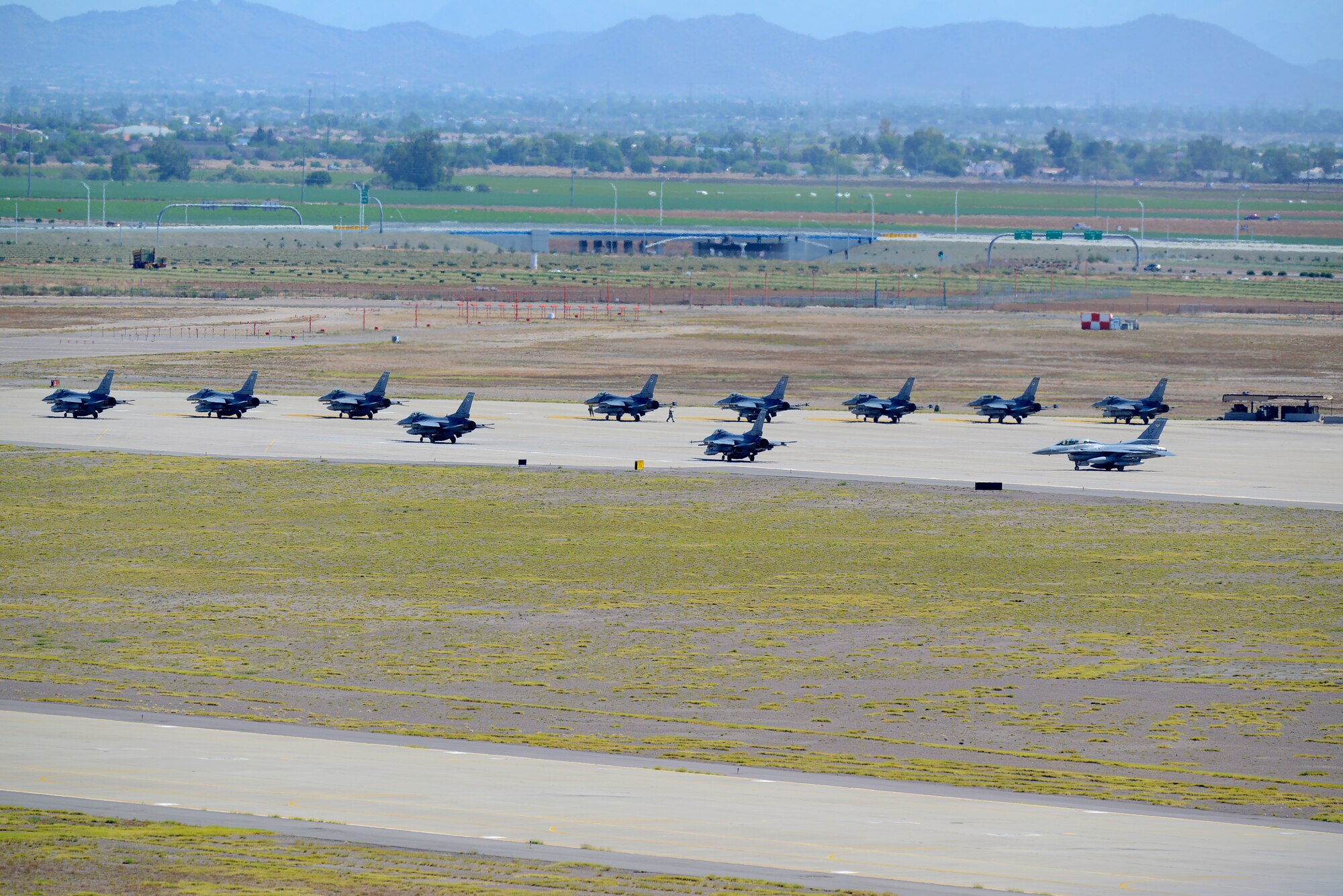 F-16 Fighting Falcons from 308th Fighter Squadron line up at the North End of Runway Tuesday at Luke Air Force Base as part of a 12-jet launch that took place to move the jets to their new home at Holloman Air Force Base, New Mexico. The 308th FS and aircraft maintenance unit officially stood down at Luke June 12 after 73 years of service. The Emerald Knight F-16s flew to Holloman where they will become the 314th FS while keeping the same mission – ‘To provide the finest single-seat, single-engine F-16 fighter pilots for the combat Air Forces and produce top quality F-16 instructor pilots.