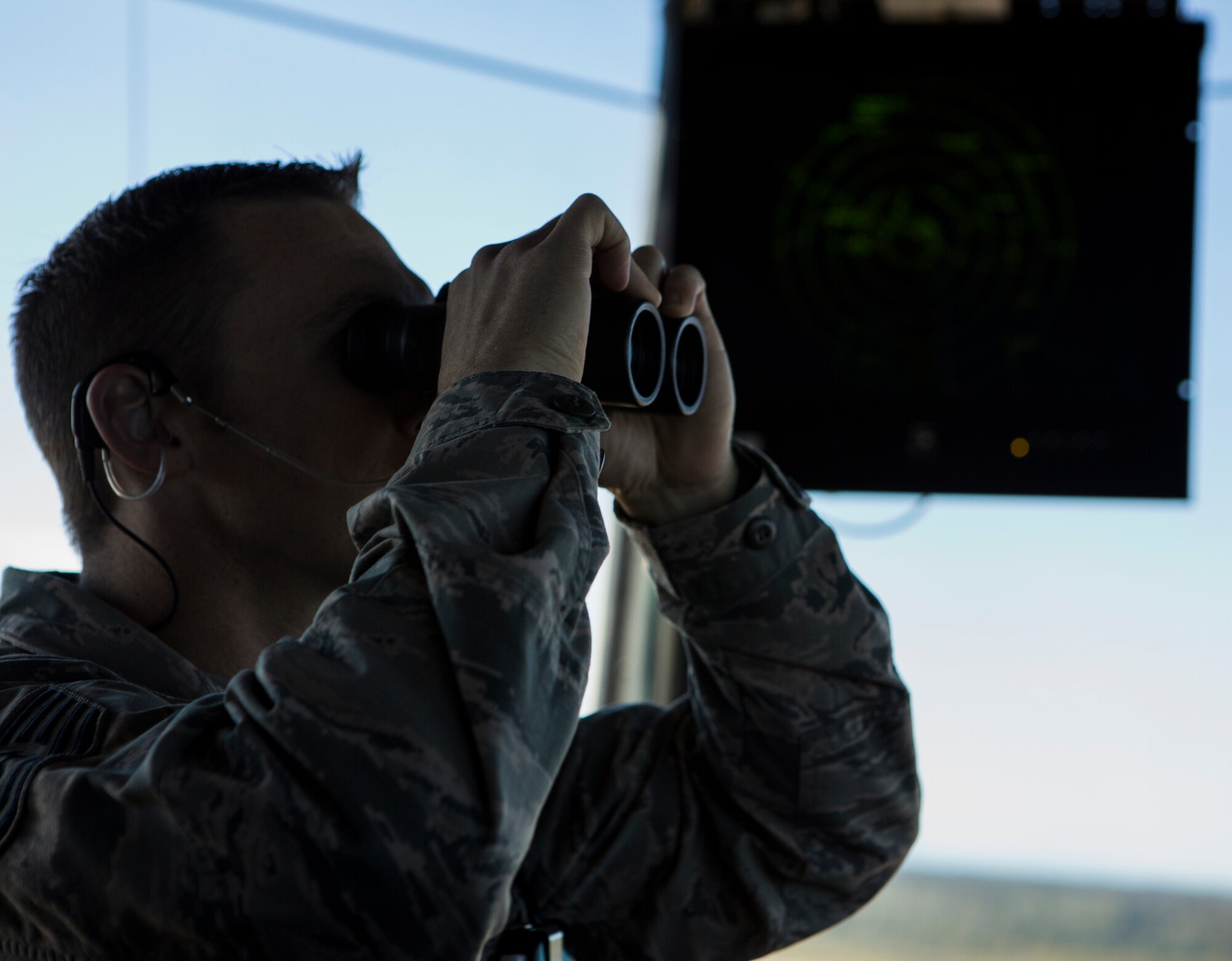 U.S. Air Force Tech. Sgt. Schyler Peck, 354th Operational Support Squadron, air traffic control watch supervisor, observes the flight line from the control tower during Exercise Northern Edge 15 at Eielson Air Force Base, Alaska, June 17, 2015. Northern Edge is Alaska’s premier joint training exercise designed to practice operations, techniques and procedures as well as enhance interoperability among the services. Thousands of Service members from active duty, Reserve and National Guard units are involved. (U.S. Marine Corps photo by Cpl. Suzanne Dickson/ Released