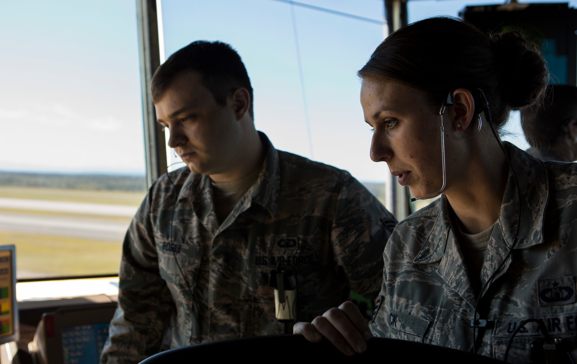 U.S. Air Force Staff Sgt. Kathleen A. Peck, right, air traffic control watch supervisor, and Staff Sgt. Anthony Fogle, air traffic controller, with 354th Operational Support Squadron, talk in the control tower during Exercise Northern Edge 15 at Eielson Air Force Base, Alaska, June 17, 2015. Northern Edge is Alaska’s premier joint training exercise designed to practice operations, techniques and procedures as well as enhance interoperability among the services. Thousands of Service members from active duty, Reserve and National Guard units are involved. (U.S. Marine Corps photo by Cpl. Suzanne Dickson/ Released)