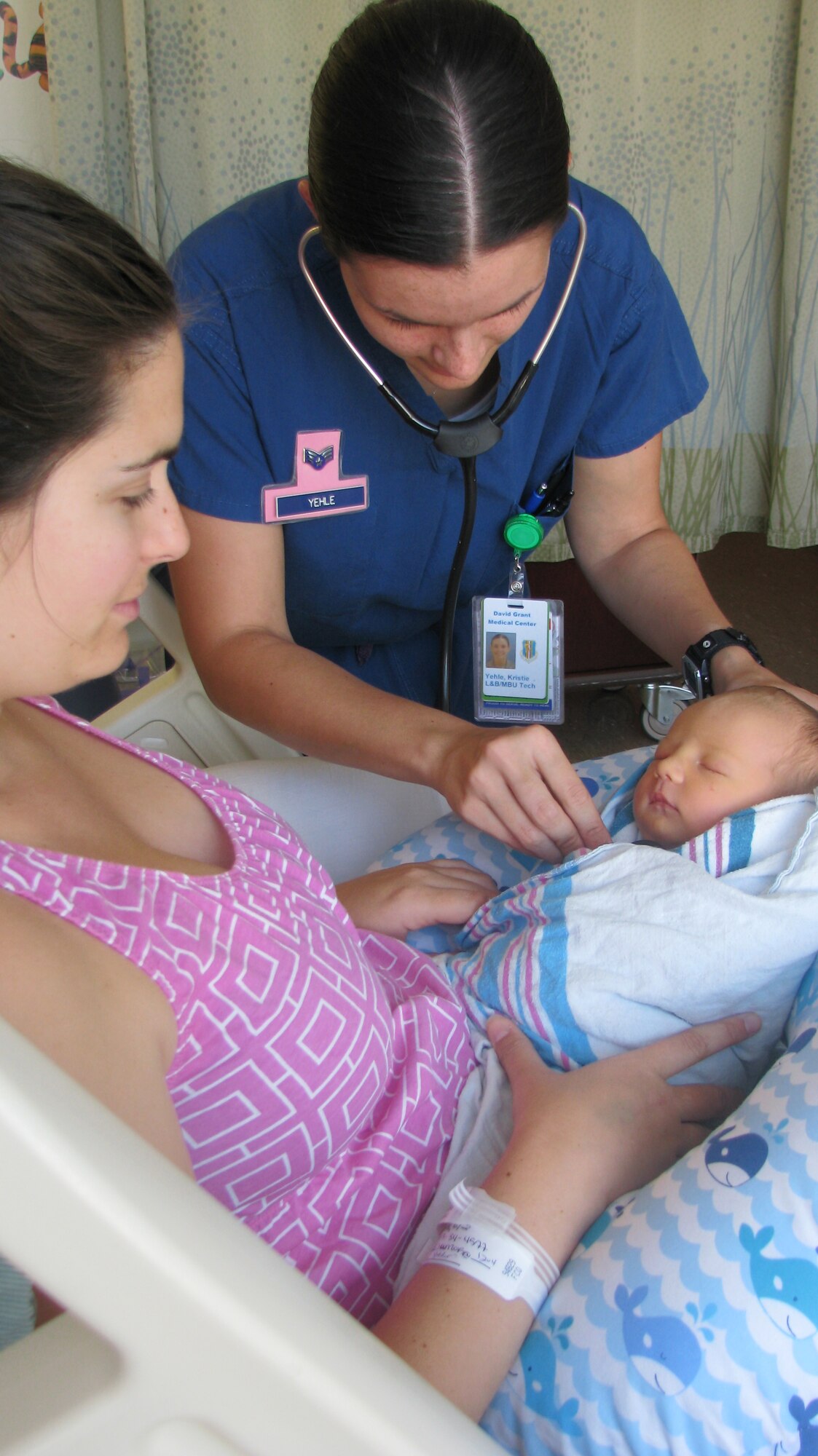 Senior Airman Kristie Yehle, 60th Inpatient Squadron aerospace medical services technician, assesses a newborn at David Grant USAF Medical Center at Travis Air Force Base, California. The Maternal Child Flight is scheduled to reveal its newly remodeled unit June 26. (Courtesy photo)