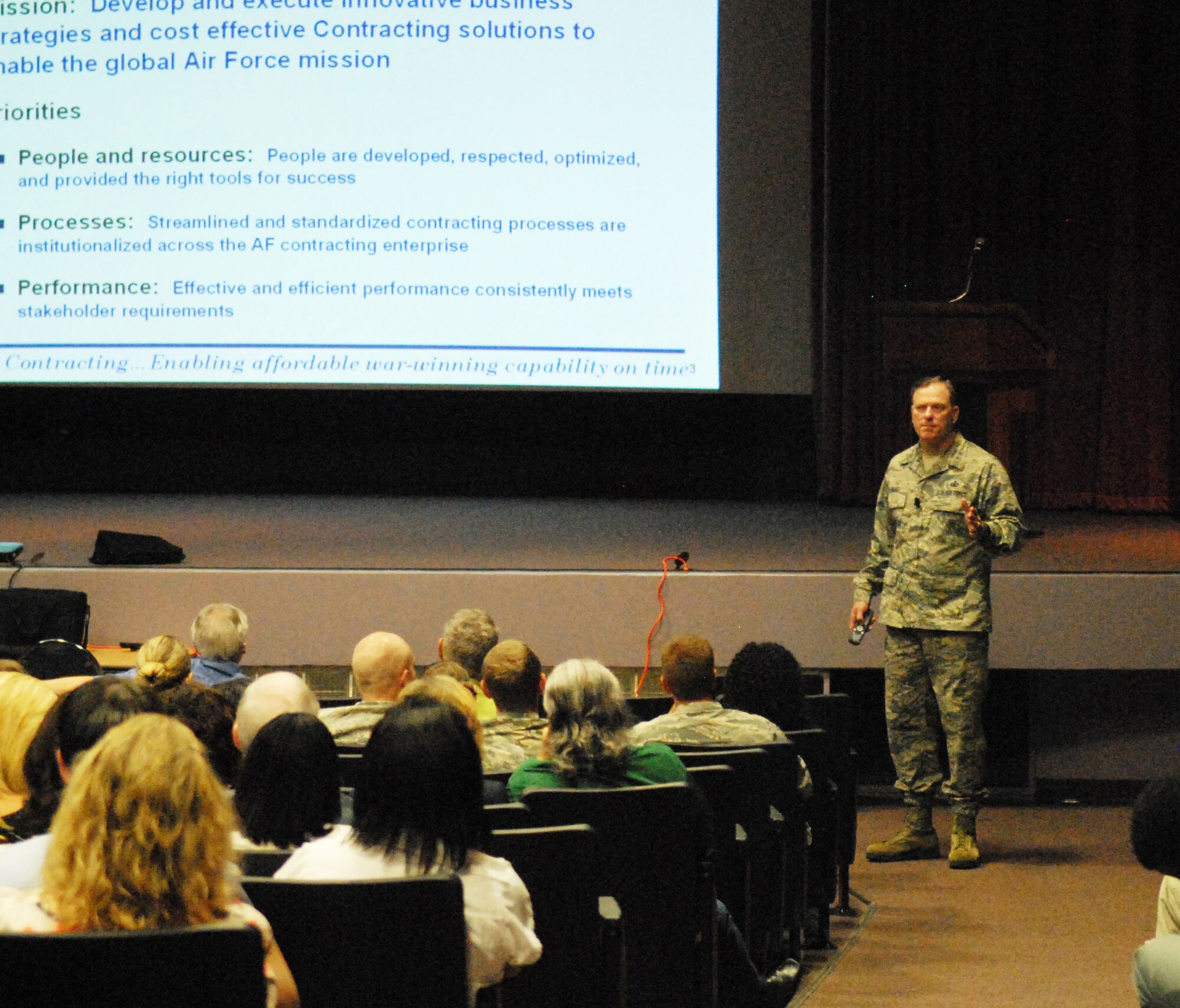 Maj. Gen. Casey Blake, deputy assistant secretary for contracting at the office of the Assistant Secretary of the Air Force for Acquisition in Washington, D.C., speaks Wednesday to Team Robins members during an all call at the base theater. (U.S. Air Force photo by Misuzu Allen)