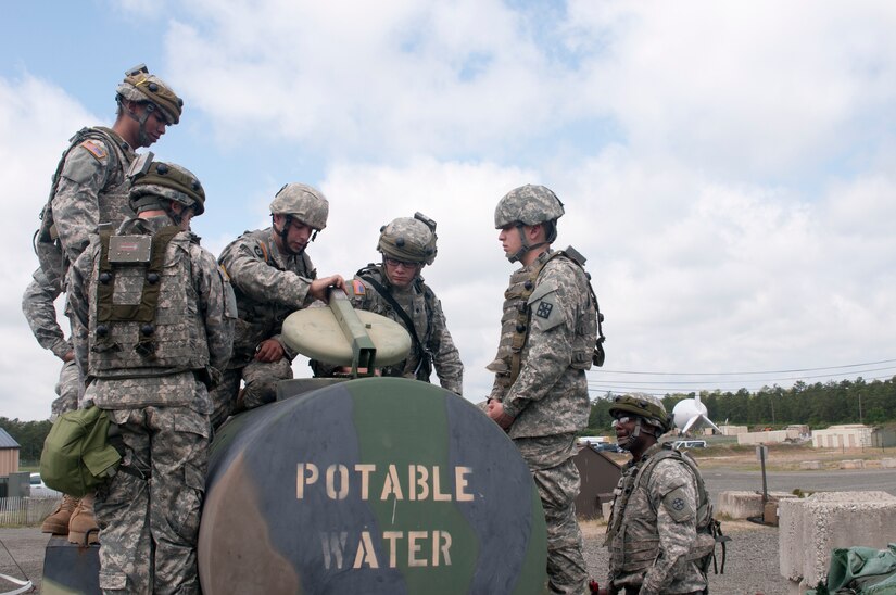 Army Reserve Sgt. George Maroukis, (center), a preventive medicine specialist of the 988th Medical Detachment from Round Rock, Texas, conducts training of a Field Sanitation Team on proper sanitation of Army M149 Water Trailers for Soldiers at COL Victory as part of the Quartermaster Liquid Logistic Exercise (QLLEX) portion of the Combat Sustainment Training Exercise (CSTX) Global Lightning 2015 at Joint Base McGuire-Dix-Lakehurst, June 11, 2015. (Photo by Spc. Samuel Al-Nimri)