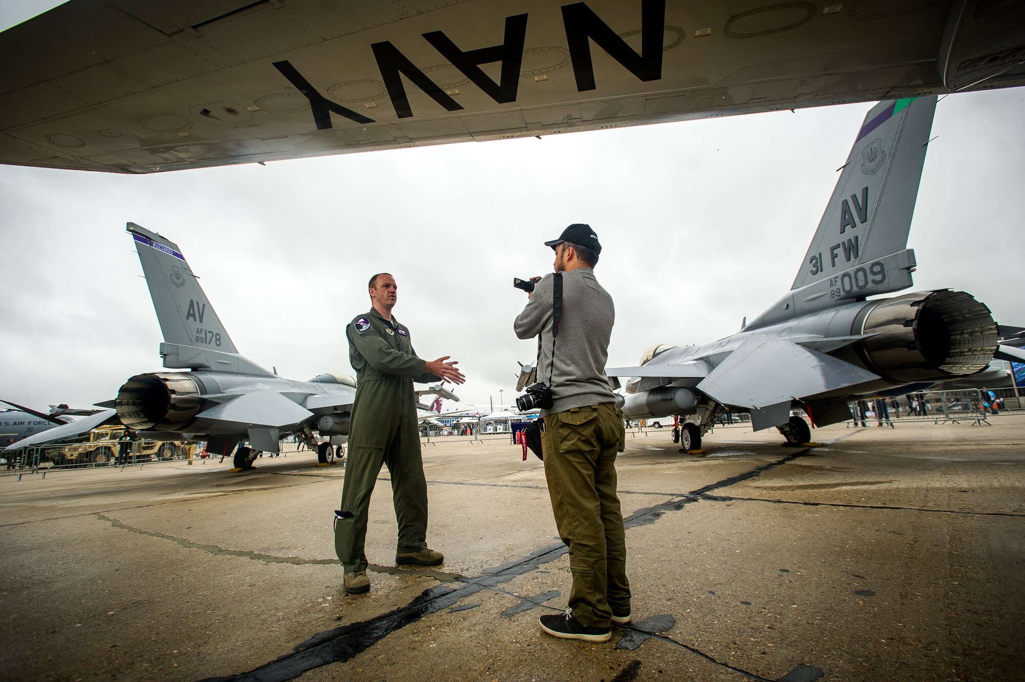 PARIS - Capt. Boot Halpin, F-16 Fighting Falcon pilot, answers questions about his jet for a reporter during the Paris Air Show at Le Bourget Airport, France, June 18, 2015. The Paris Air Show provides a collaborative opportunity to share and strengthen the U.S. and European strategic partnership that has been forged during the last seven decades and is built on a foundation of shared values, experiences and vision. The event is expected to bring in 315,000 people, a record 2,215 companies, 150 aircraft, and will span 324,000 square meters. (U.S. Air Force photo/ Tech. Sgt. Ryan Crane)