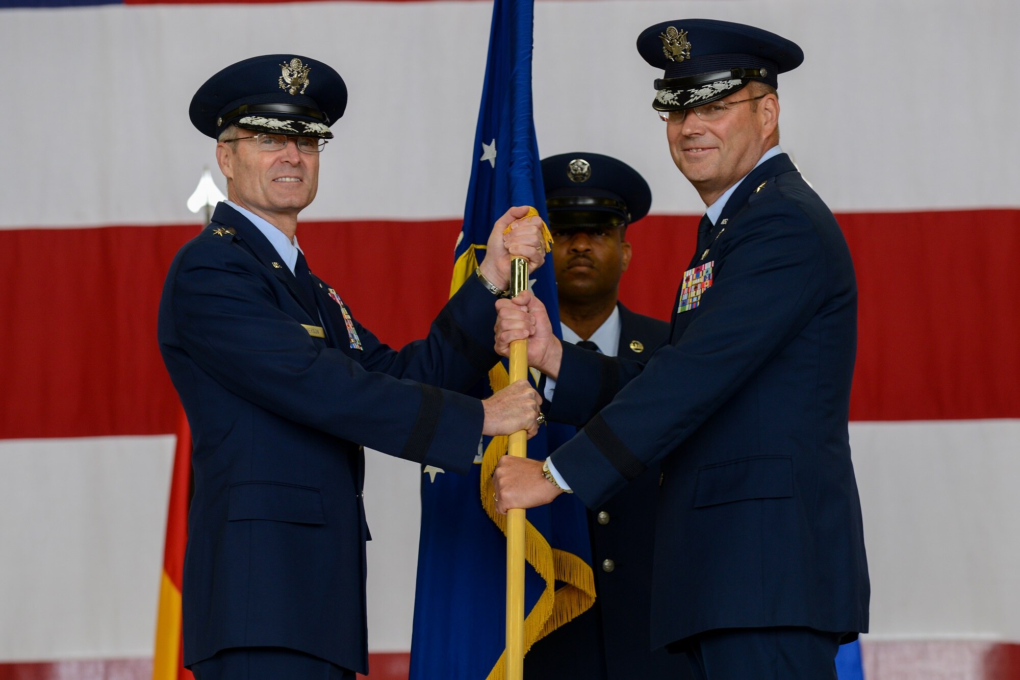 Brig. Gen. Jon T. Thomas (right) 86th Airlift Wing commander, takes the wing’s guidon from Lt. Gen. Darryl L. Roberson, 3rd Air Force and 17th Expeditionary Air Force commander, June 19, 2015, Ramstein Air Base, Germany.  It is military tradition for the guidon to be exchanged between commanders to symbolize the passing of command. (U.S. Air Force photo/Senior Airman Nicole Sikorski)