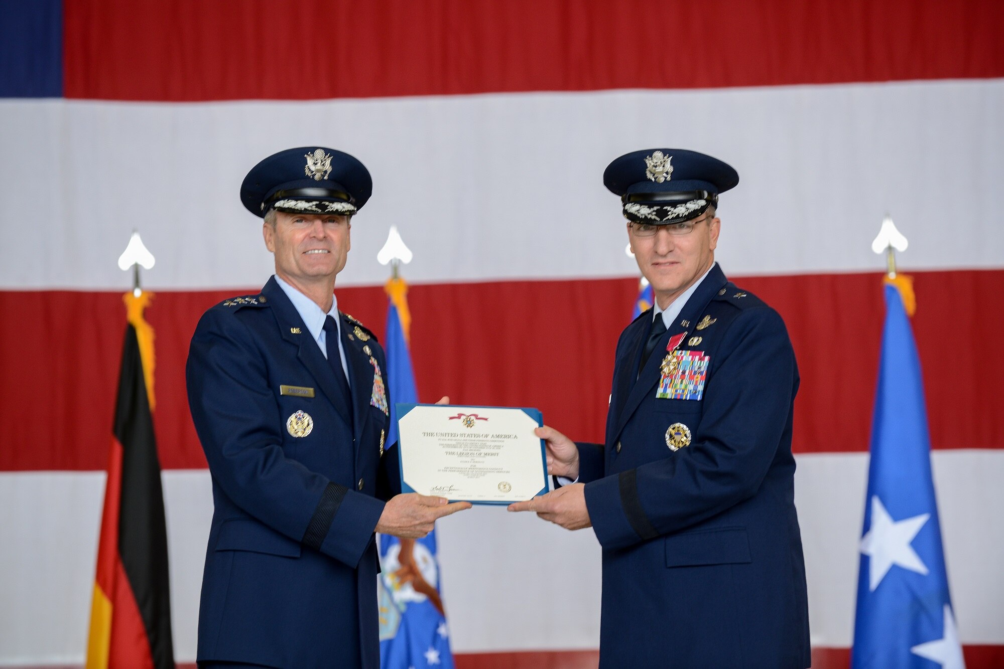 Lt. Gen. Darryl L. Roberson, 3rd Air Force and 17th Expeditionary Air Force commander, presents the Legion of Merit, first oak leaf cluster  to Brig. Gen. Patrick X. Mordente, 86th Airlift Wing outgoing commander, during a change of command ceremony June 19, 2015, Ramstein Air Base, Germany.  Brig. Gen. Jon T. Thomas assumed command of the 86th AW and is taking command of the largest wing in Europe. (U.S. Air Force photo/Senior Airman Nicole Sikorski)
