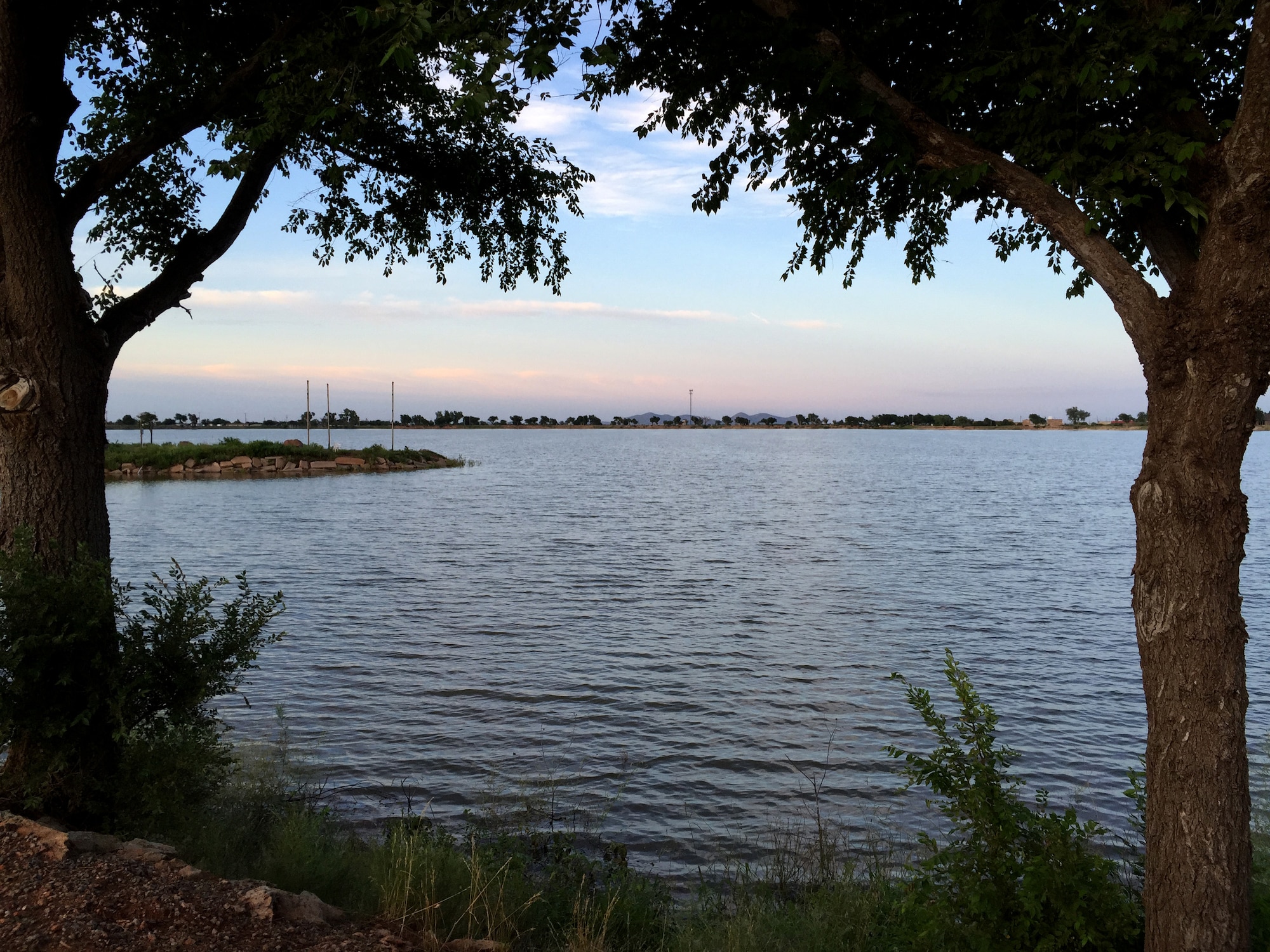The sun sets at the Altus city reservoir, now filled with water, June 18, 2015. Altus has received 22.2 inches of rainfall in 2015, more than the entire last year, and releases from Tom Steed Reservoir have filled the reservoir. (U.S. Air Force photo by Staff Sgt. Nathanael Callon/Released)