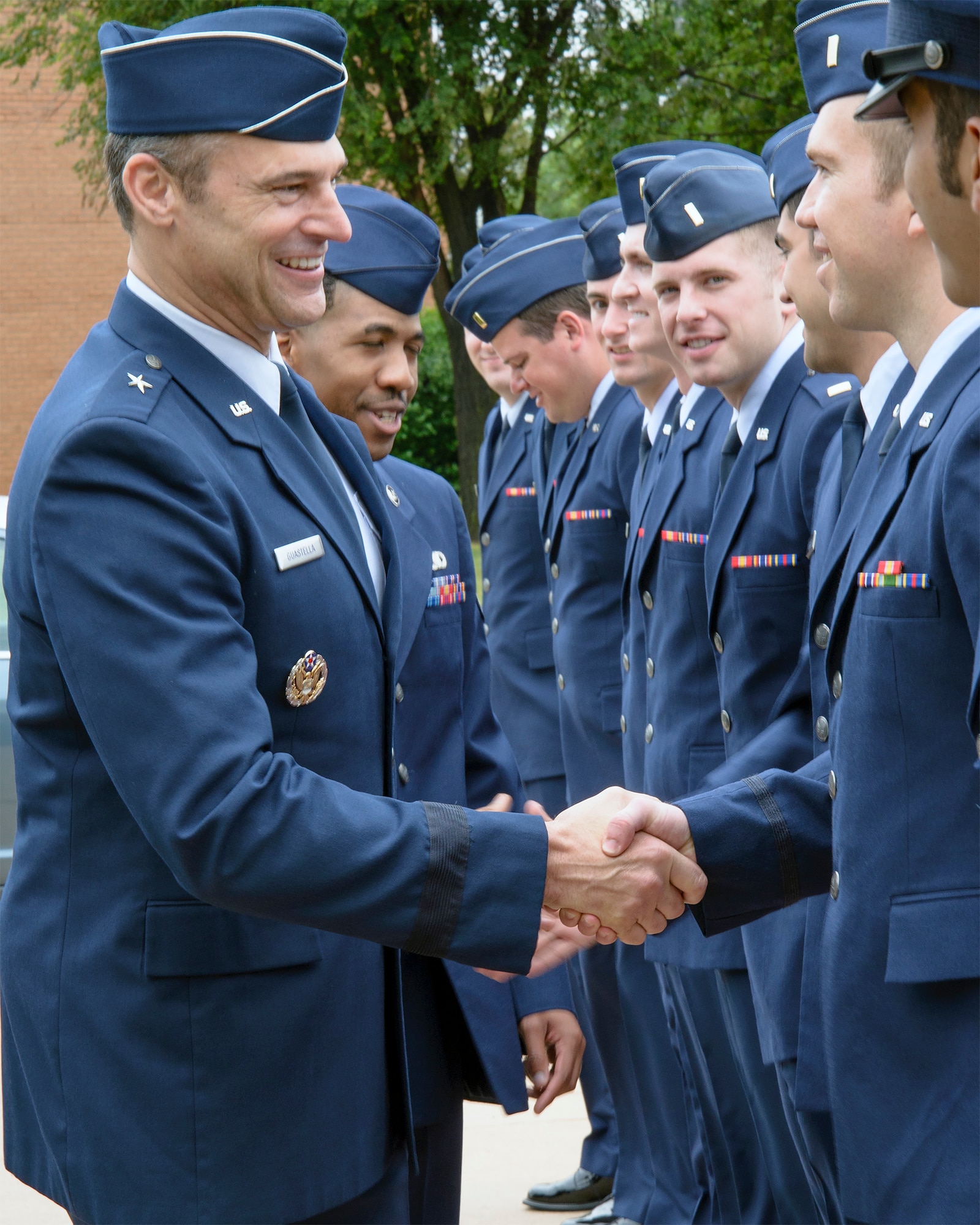 Brig. Gen. Joseph Guastella, the deputy director for requirements (J8), Joint Staff, the Pentagon, greets Joint Specialized Undergraduate Pilot Training Class 15-10 graduates at Vance Air Force Base, Oklahoma, June 12. (U.S. Air Force photo / David Poe)