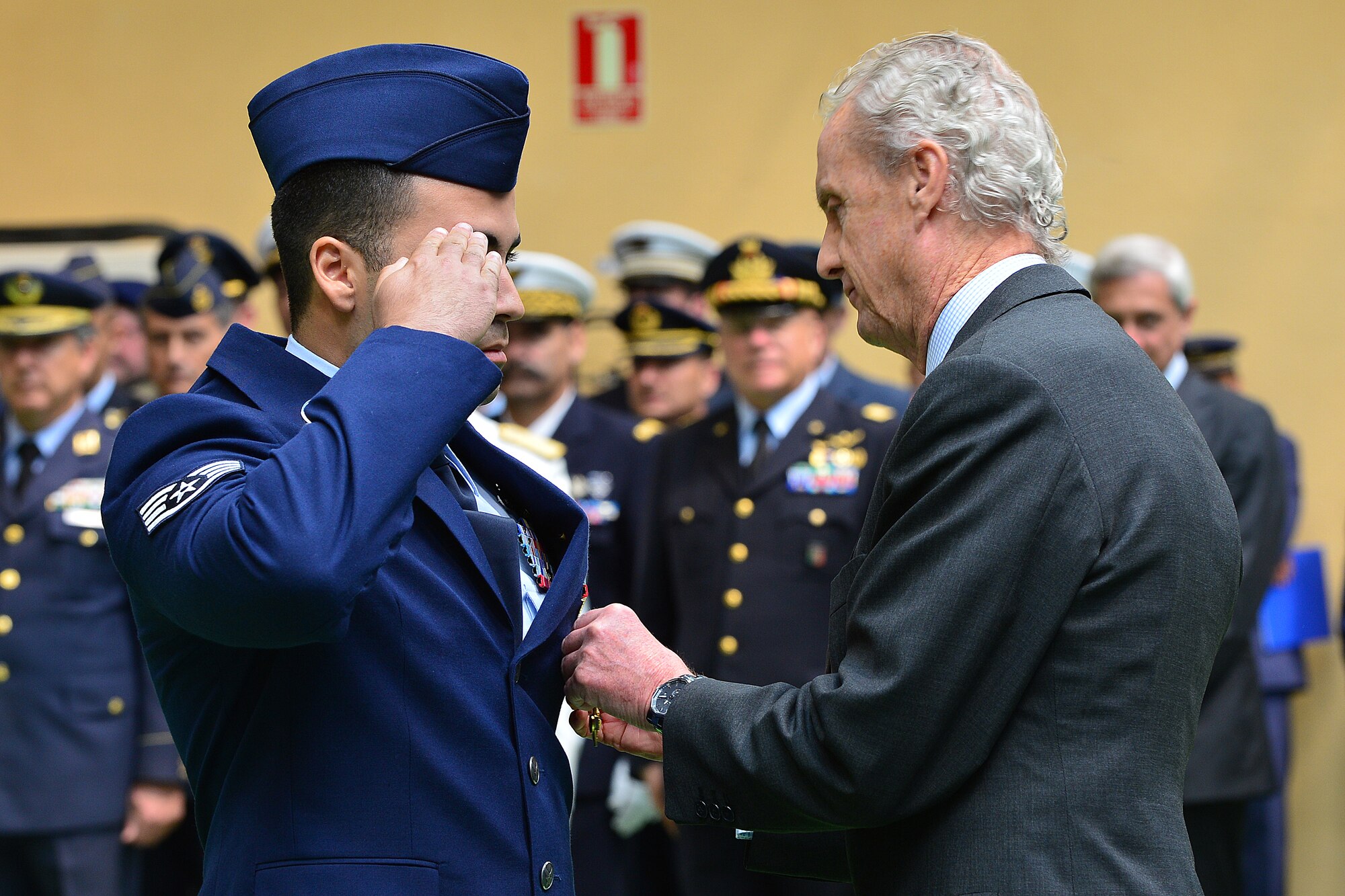 Staff Sgt. John Escalante, 5th Munitions Squadron, Minot Air Force Base, South Dakota, receives the Spanish Cross of Aeronautical Merit medal from the Spanish Minister of Defence, Pedro Morenes, at Albacete Air Base, Spain, June 18, 2015. The Spanish Cross of Aeronautical Merit medals are awarded to individuals for actions, deeds or service that pose serious risk in cases of injury or death as a result of acts of service. (U.S. Air Force photo by Staff Sgt. Stephanie Longoria/Released)