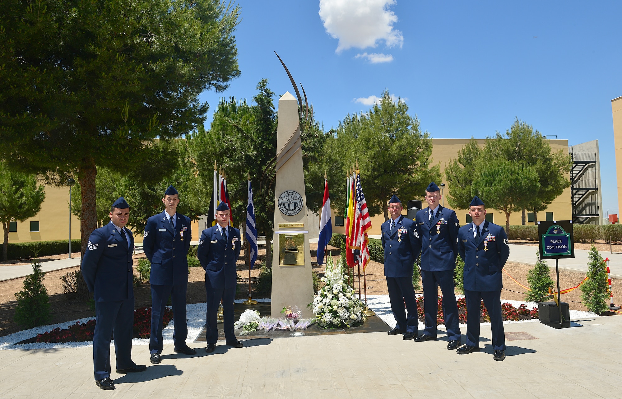U.S. Air Force Airmen and Spanish Cross of Aeronautical Merit recipients pose for a group photo in front of a memorial statue, at Albacete Air Base, Spain, June 18, 2015.  A memorial service was held to honor the 11 fallen comrades that died from a Hellenic F-16 crash at Tactical Leadership Program 15-1, Jan. 26, 2015. Four of the six Airmen are assigned to Royal Air Force Lakenheath, and received the medals for their heroic actions that saved the lives of three French Airmen. (U.S. Air Force photo by Staff Sgt. Stephanie Longoria/Released)