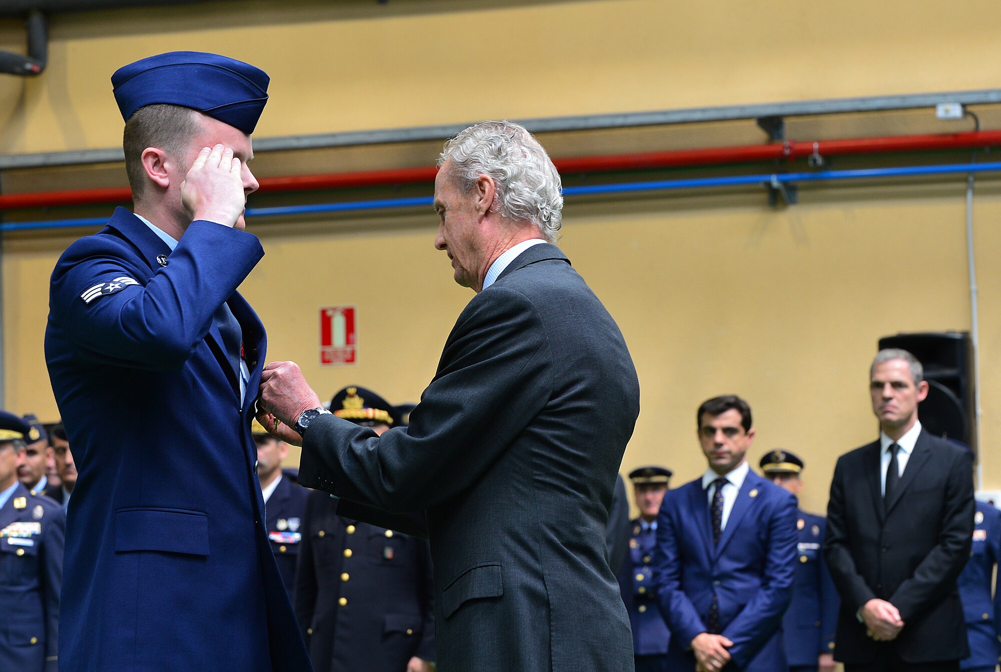Senior Airman Matthew Jeffers, 48th Aircraft Maintenance Squadron, receives the Spanish Cross of Aeronautical Merit medal from the Spanish Minister of Defence, Pedro Morenes, during a at Albacete Air Base, Spain, June 18, 2015. Four Airmen from Royal Air Force Lakenheath received the medals for their heroic actions when a Hellenic F-16 crashed during Tactical Leadership Program 15-1. (U.S. Air Force photo by Staff Sgt. Stephanie Longoria/Released)