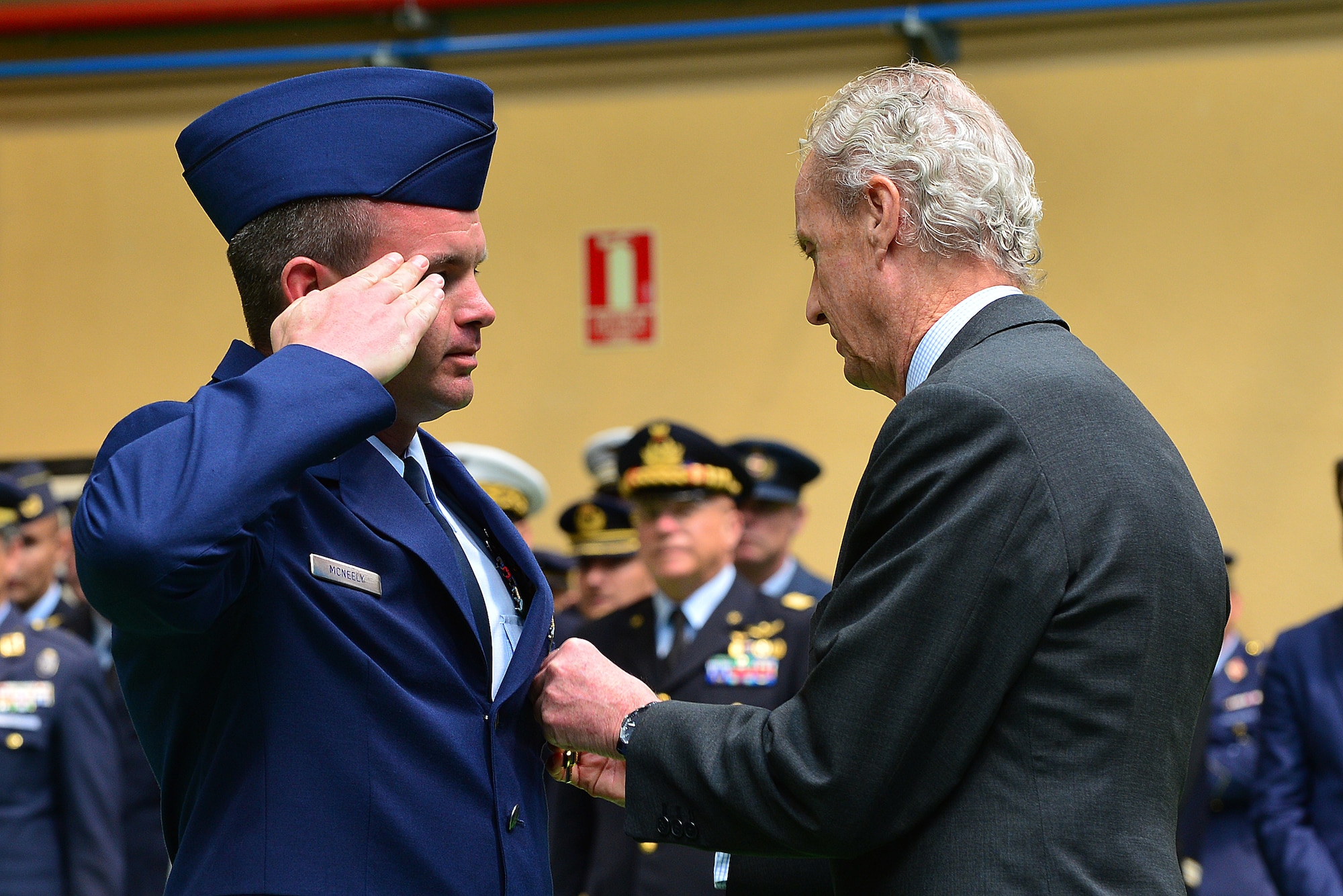 Master Sgt. Jonathan McNeely, Albacete Air Base aerospace maintenance coordinator, receives the Spanish Cross of Aeronautical Merit medal from the Spanish Minister of Defence, Pedro Morenes, at Albacete Air Base, Spain, June 18, 2015. The Spanish Cross of Aeronautical Merit medals are awarded to individuals for actions, deeds or service that pose serious risk in cases of injury or death as a result of acts of service. (U.S. Air Force photo by Staff Sgt. Stephanie Longoria/Released)