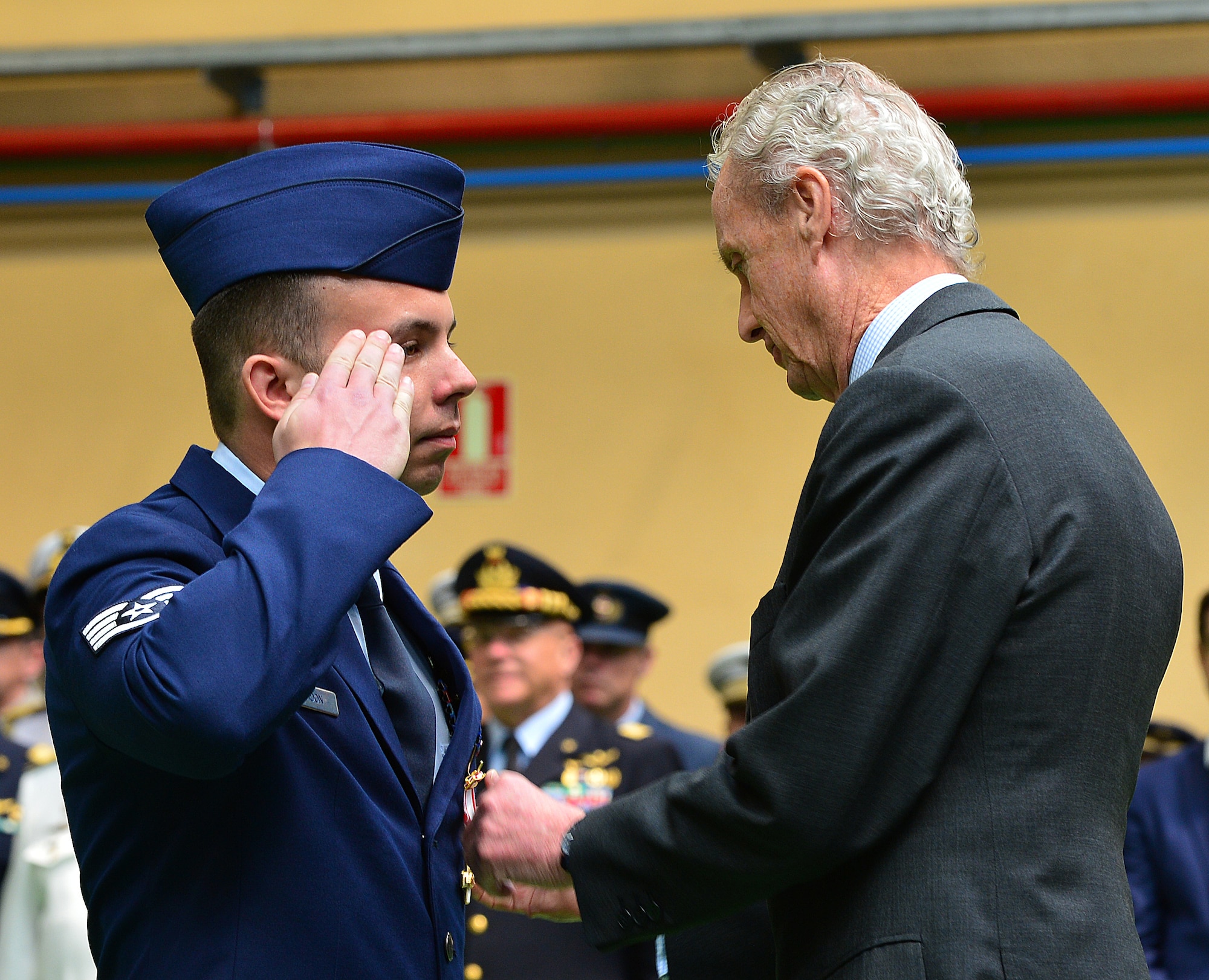 Staff Sgt. Eli Gordon, 48th Aircraft Maintenance Squadron, receives the Spanish Cross of Aeronautical Merit medal from the Spanish Minister of Defence, Pedro Morenes, at Albacete Air Base, Spain, June 18, 2015. Four Airmen from Royal Air Force Lakenheath received the medals for their heroic actions when a Hellenic F-16 crashed during Tactical Leadership Program 15-1. (U.S. Air Force photo by Staff Sgt. Stephanie Longoria/Released)