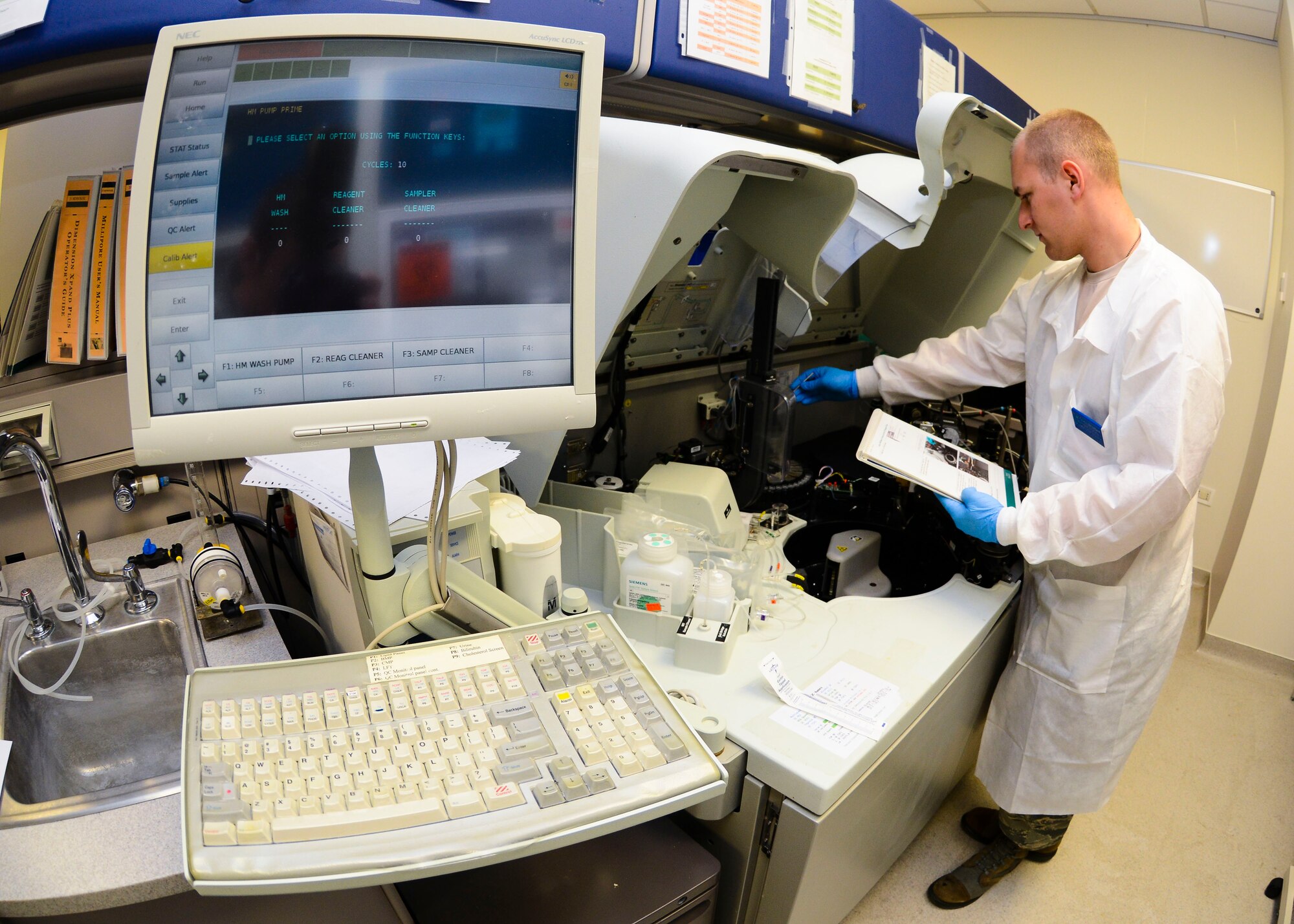 U.S. Air Force Staff Sgt. Grant Wendland, 31st Medical Support Squadron medical laboratory technician, cleans a chemistry testing machine, June 15, 2015, at Aviano Air Base, Italy. This machine performs many of the common tests used by the lab, such as cholesterol panels, quantitative pregnancy tests and blood alcohol content evaluations. (U.S. Air Force photo by Senior Airman Austin Harvill/Released)