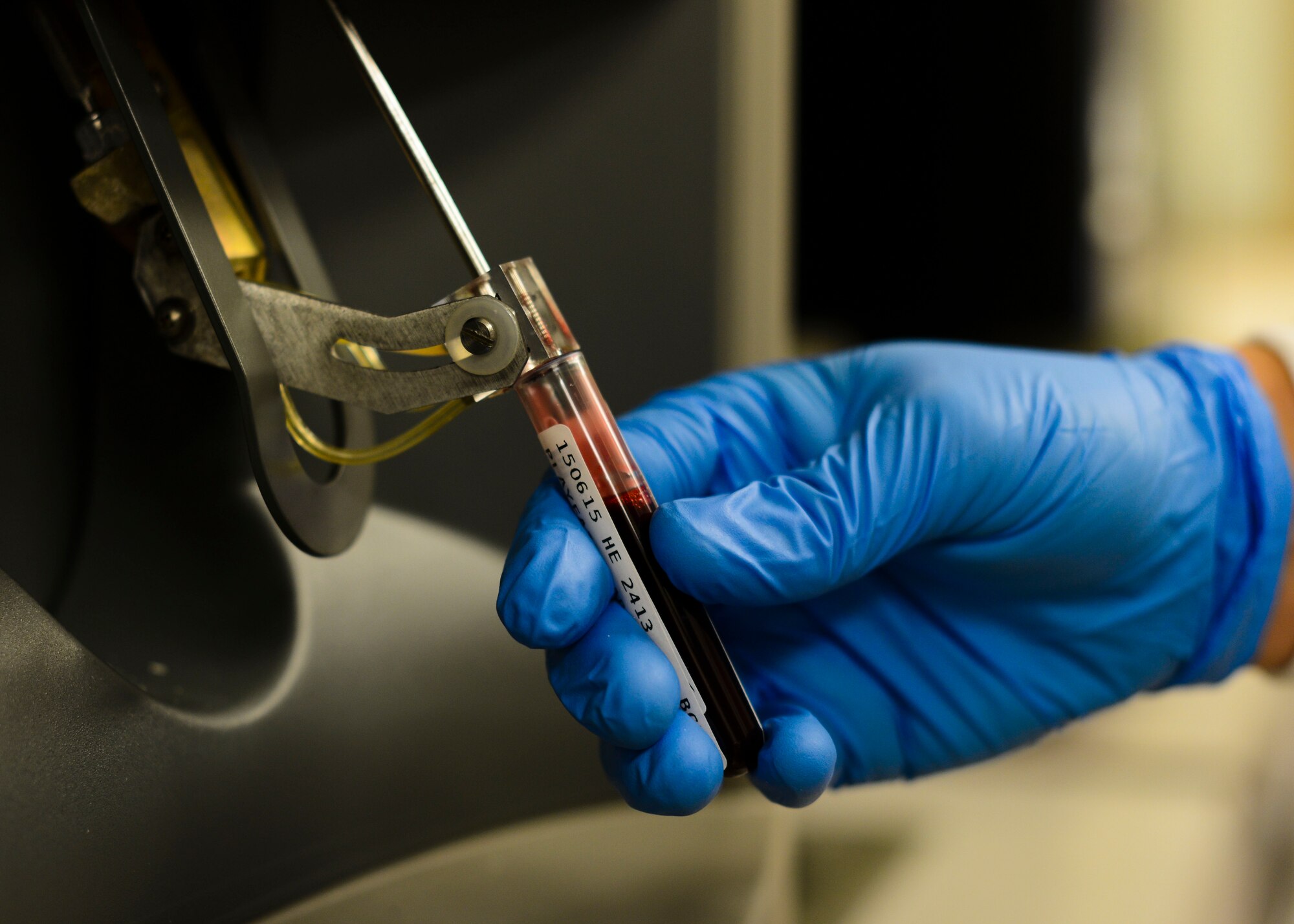 A 31st Medical Support Squadron laboratory technician runs a blood sample through a complete blood count test, June 15, 2015, at Aviano Air Base, Italy. While machines run the tests, technicians validate the results through additional testing and quality assurance checks. (U.S. Air Force photo by Senior Airman Austin Harvill/Released)