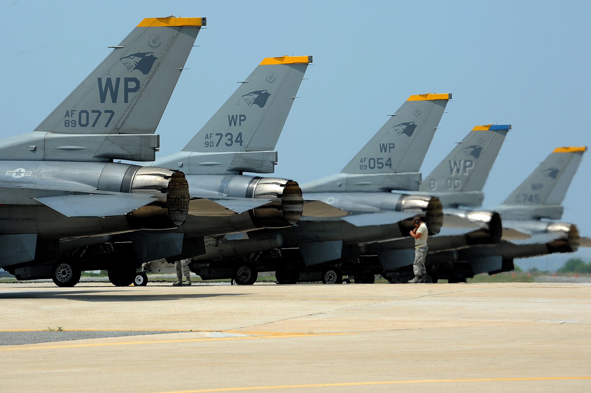 F-16 Fighting Falcons line up on the runway before taking off during Surge Week at Kunsan Air Base, Republic of Korea, June 18, 2015. Surge Week tested the skills and wartime capabilities of Wolf Pack operators, maintainers and supporting agencies over a four-day window to simulate pilots' wartime flying rates. (U.S. Air Force photo by Senior Airman Divine Cox/Released)