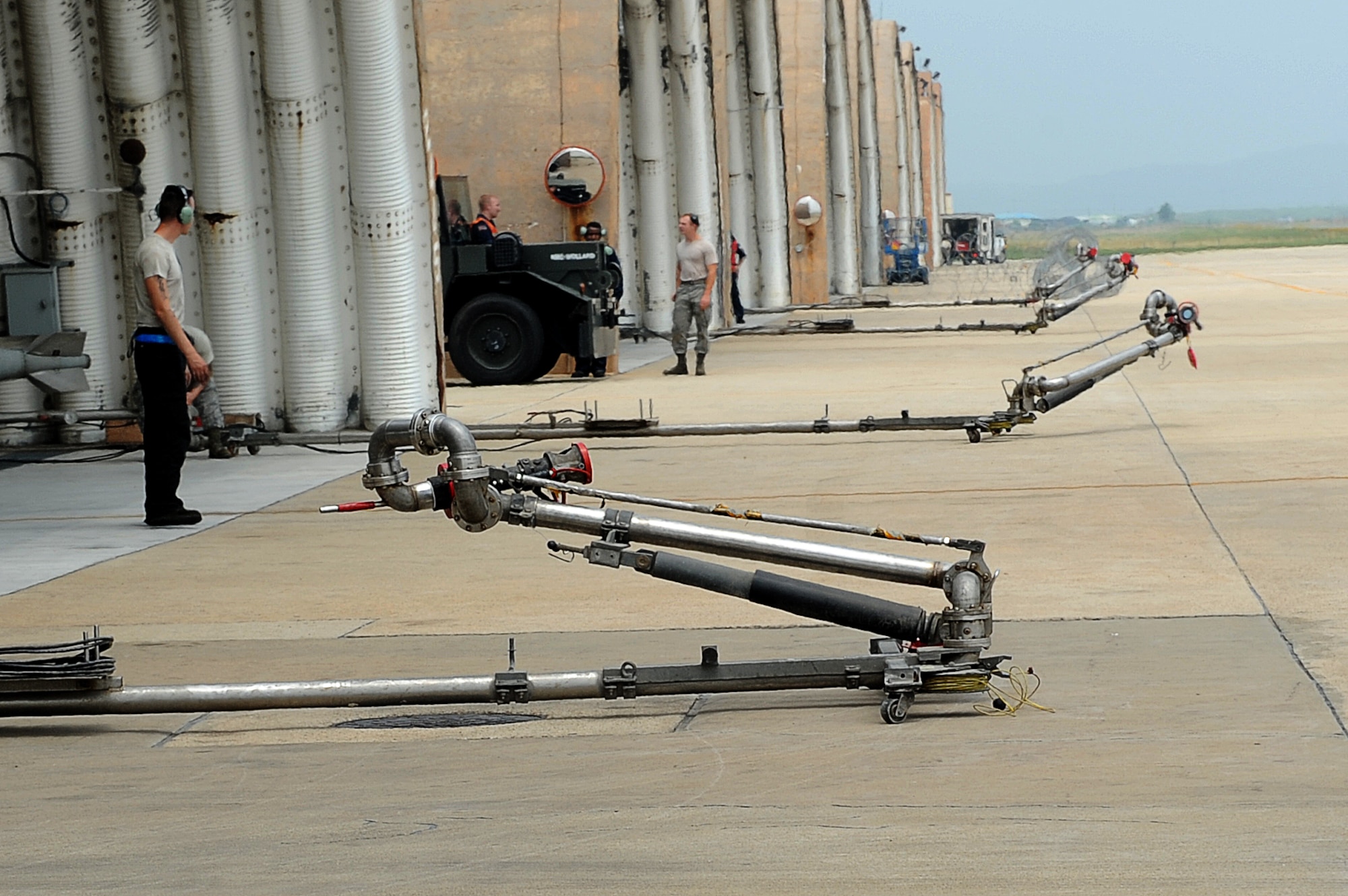 Kunsan Airmen wait to refuel F-16s during Surge Week at Kunsan Air Base, Republic of Korea, June 16, 2015. Pilots and maintainers conducted hot pit refueling to rapidly refuel each aircraft and allow it to complete a second sortie, thereby maximizing the sorties flown in a short amount of time. (U.S. Air Force photo by Senior Airman Divine Cox/Released)