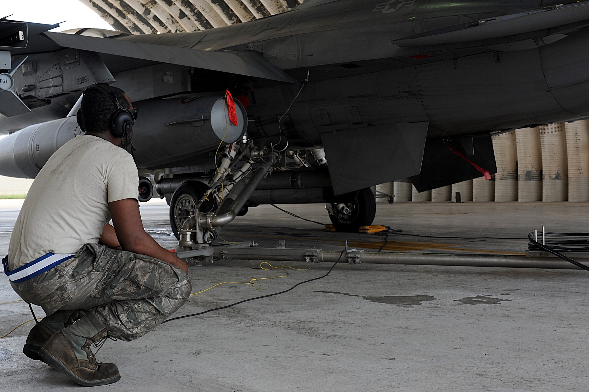 Senior Airman Miller Gardner, 8th Aircraft Maintenance Squadron avionics technician, monitors hot refueling performed on an F-16 Fighting Falcon during Surge Week at Kunsan Air Base, Republic of Korea, June 16, 2015. Pilots and maintainers conducted hot pit refueling to rapidly refuel each aircraft and allow it to complete a second sortie, thereby maximizing the sorties flown in a short amount of time. (U.S. Air Force photo by Senior Airman Divine Cox/Released)