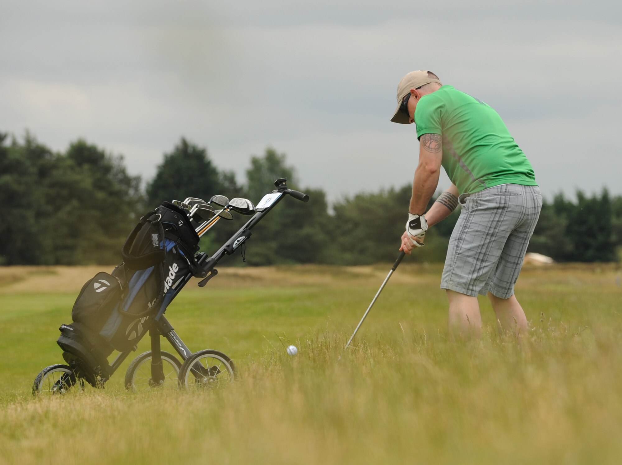 Marshall Spooner, 100th Logistics Readiness Squadron NCO in charge of fuels support section from St. Charles, Mo, chips out of the deep rough on the 390-yard par 4 third hole during the RAF Mildenhall intramural golf match June 17, 2015, at Breckland Pines Golf Club on RAF Lakenheath, England.  The 352nd Special Operations Aircraft Maintenance Squadron won with an overall score of 8-4 against the 100th LRS. (U.S. Air Force photo by Gary Rogers/Released)