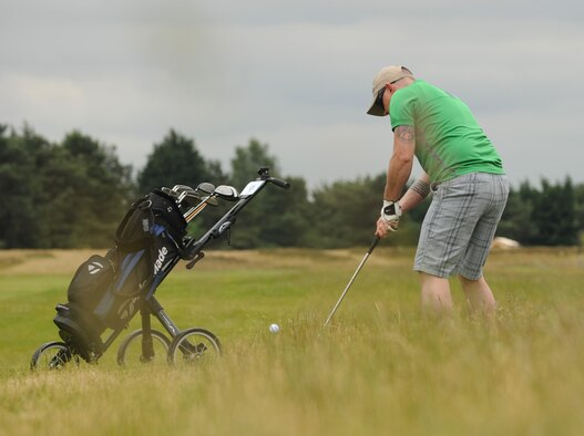Marshall Spooner, 100th Logistics Readiness Squadron NCO in charge of fuels support section from St. Charles, Mo, chips out of the deep rough on the 390-yard par 4 third hole during the RAF Mildenhall intramural golf match June 17, 2015, at Breckland Pines Golf Club on RAF Lakenheath, England.  The 352nd Special Operations Aircraft Maintenance Squadron won with an overall score of 8-4 against the 100th LRS. (U.S. Air Force photo by Gary Rogers/Released)
