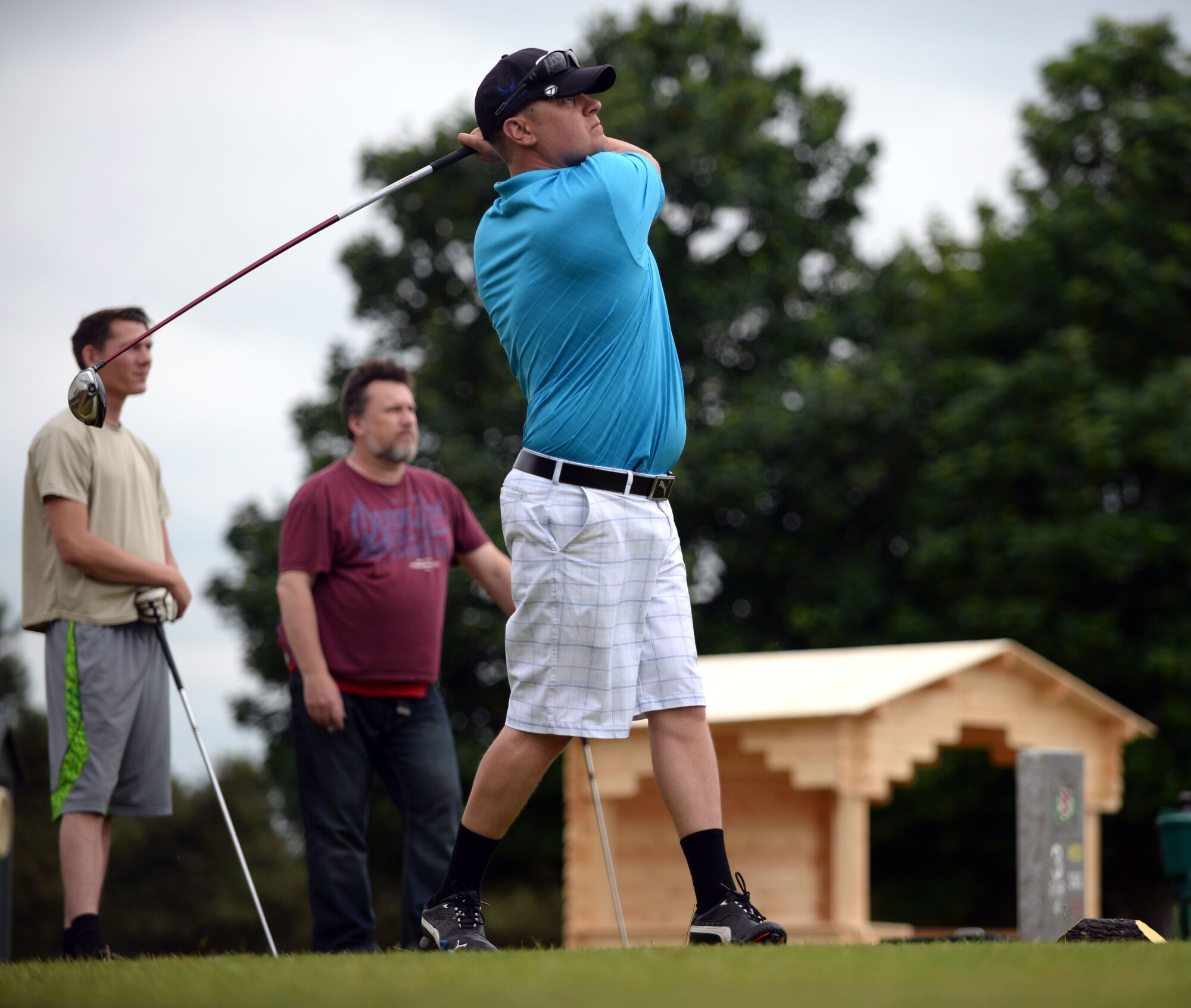 Matthew Gruber, 352nd Special Operations Maintenance Squadron NCO in charge of aero-repair wheel and tire from Martin, Mich., hits his drive at the 390-yard par 4 hole during the RAF Mildenhall intermural golf match, June 17, 2015, at the Breckland Pines Golf Club on RAF Lakenheath, England. The golfers were playing scramble formation, where all members of the team hit from the same spot throughout the hole, using the best shot each time to determine the location of the next shot. (U.S. Air Force photo by Senior Airman Christine Halan/Released)