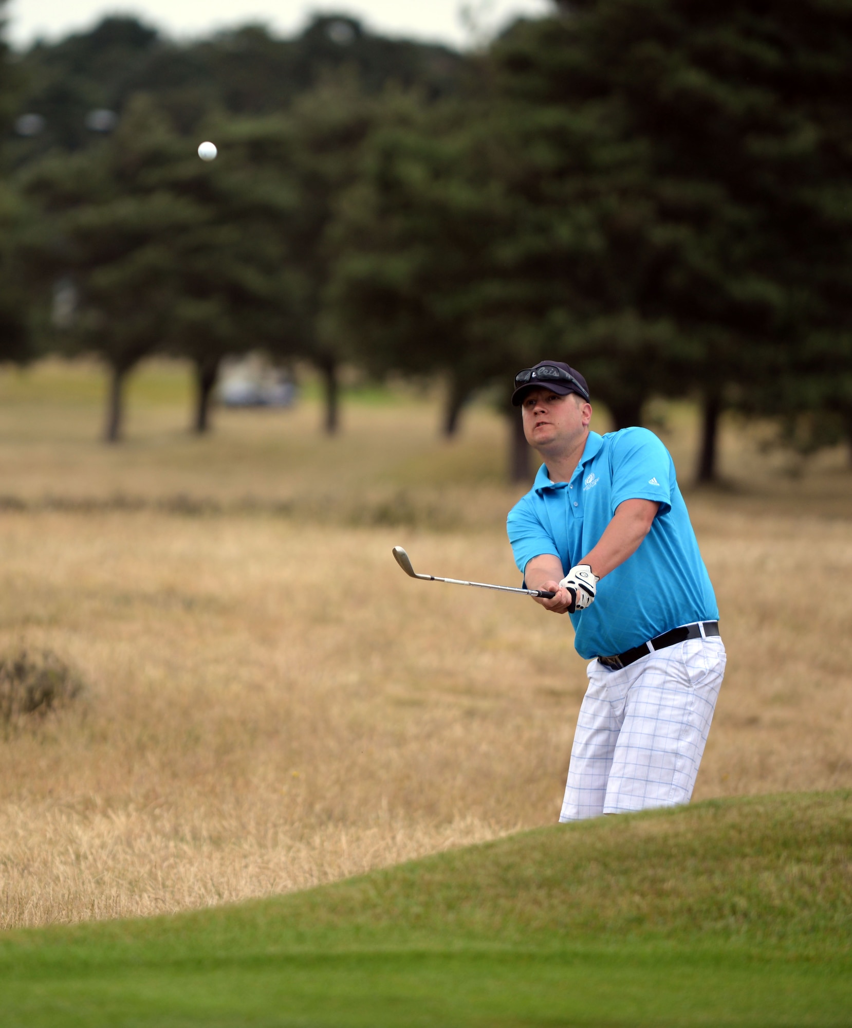 Matthew Gruber, 352nd Special Operations Maintenance Squadron NCO in charge of aero-repair wheel and tire from Martin, Mich., plays out of the greenside bunker on the 330-yard par-4 first hole during an RAF Mildenhall Intermural Golf match, June 17, 2015, at the Breckland Pines Golf Club on RAF Lakenheath, England. Breckland Pines is a nine-hole heathland type course with 18 different tee positions. The intramural sport promotes friendly competition, moral and fun for Airmen across the different units on base.(U.S. Air Force photo by Senior Airman Christine Halan/Released)