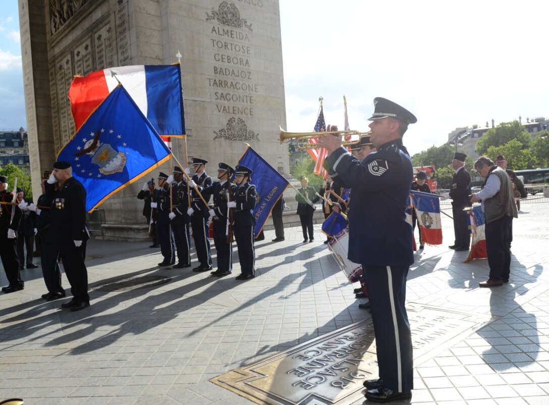 Master Sgt. Dave Dell, U.S. Air Forces in Europe Band, concludes a Memorial Day ceremony with the playing of “Taps” at the Arc de Triomphe, Paris, France, May 24, 2015. Approximately 200 U.S. service members and civilians attended the ceremony to pay tribute to fallen comrades. (U.S. Air Force photo by Maj. Sheryll Klinkel/Released)