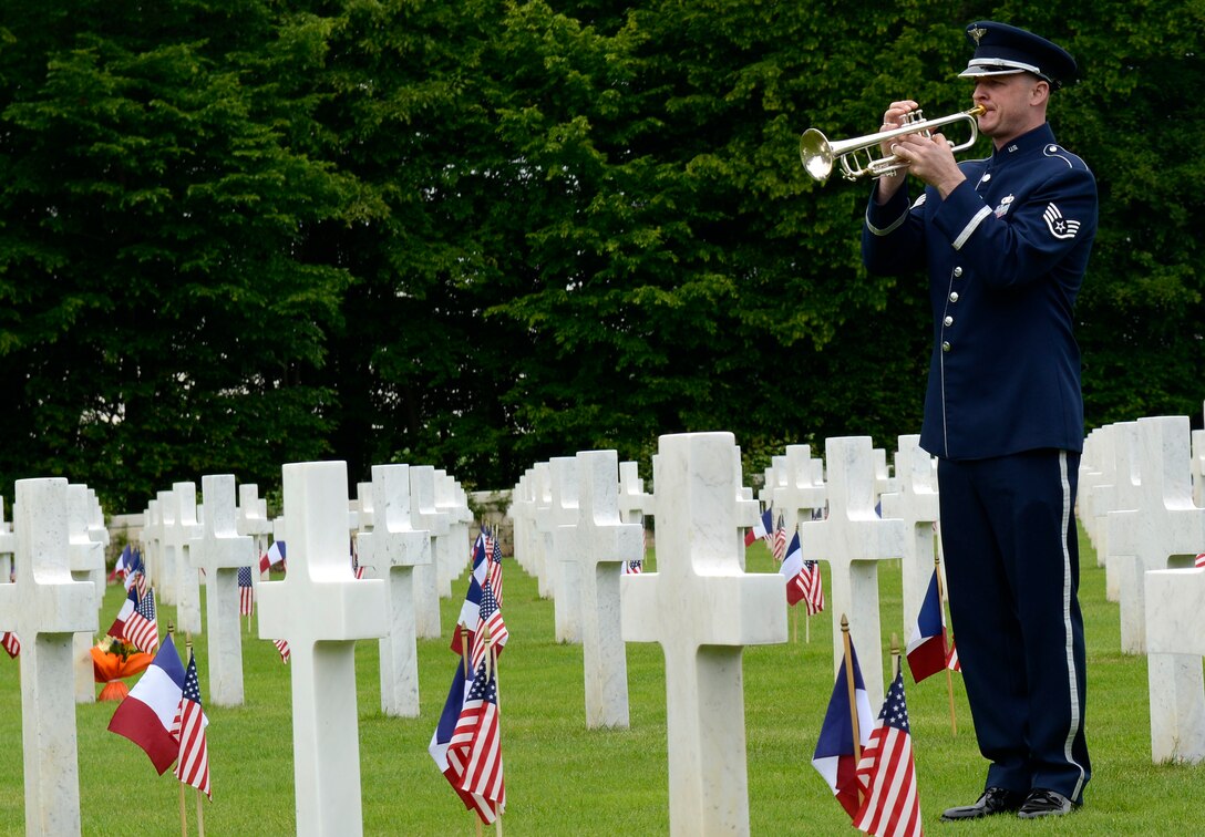 Staff Sergeant Ken Jones from the U.S. Air Forces in Europe Band plays taps during a Memorial Day ceremony at St. Mihiel American Cemetery May 24, 2015, in Thiaucourt, France. More than 4,100 U.S. military members from World War I are buried in the cemetery where local community leaders gathered with U.S. Air Forces in Europe servicemembers to honor the fallen to commemorate Memorial Day. (U.S. Air Force photo/Airman 1st Class Tryphena Mayhugh)