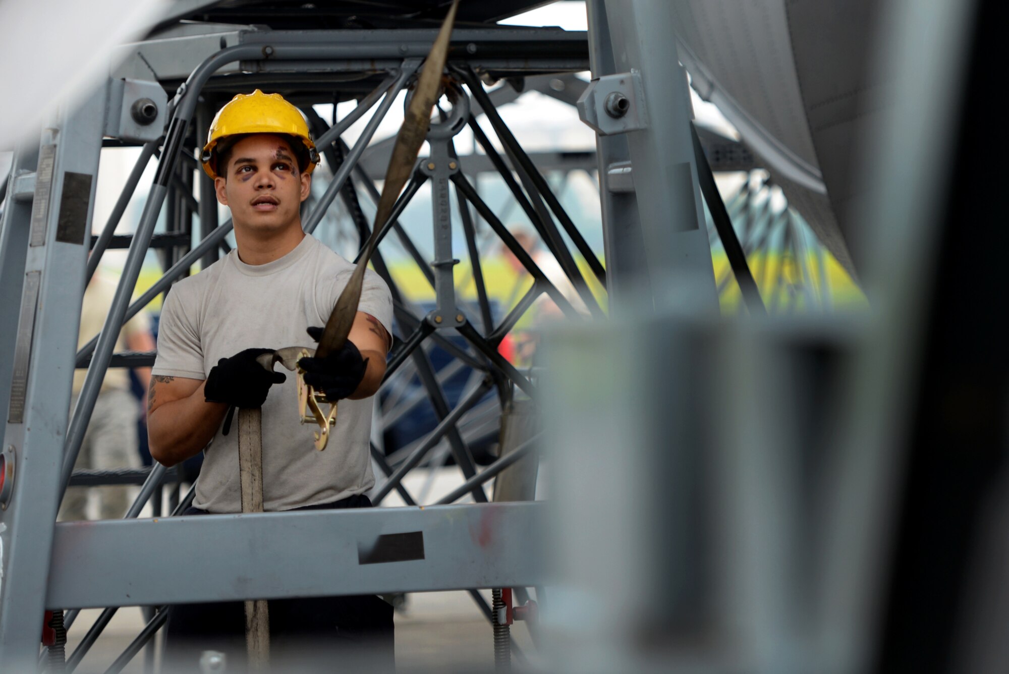 An Airman from the 374th Maintenance Squadron works to lower an engine from a MC-130 Combat Talon II onto a dolly June 18, 2015, at Yokota Air Base, Japan. The MXS worked to ensure the aircraft is prepared to respond to any type of mission - day or night. (U.S. Air Force photo by Airman 1st Class Delano Scott/Released)