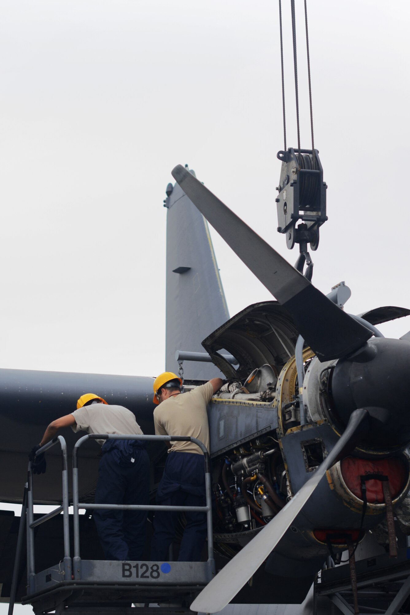 374th Maintenance Squadron Airmen prepare to extract an engine from a MC-130 Combat Talon II, June 18, 2015, at Yokota Air Base, Japan.  The 374 MXS Airmen ensured that the MC-130 remains in top condition. (U.S. Air Force photo by Airman 1st Class Delano Scott/Released)
