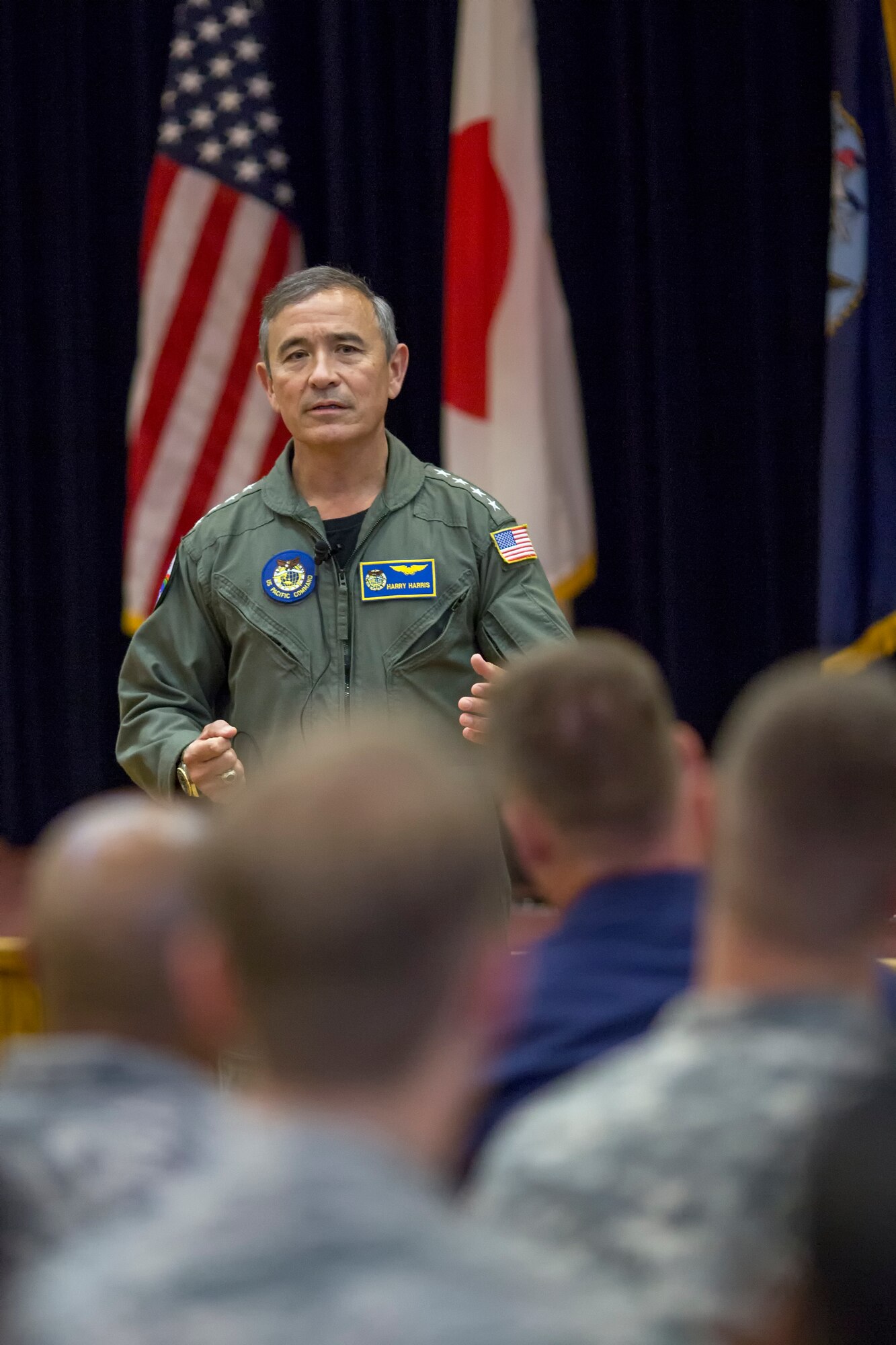 U.S. Pacific Command Commander Adm. Harry B. Harris Jr., addresses an audience of Team Yokota service members during a town hall meeting at Yokota Air Base, Japan, June 11, 2015. Harris visited Yokota during his first official visit to the Indo-Asia Pacific region, with stops in Korea and Japan. (U.S. Air Force photo by Osakabe Yasuo/Released)