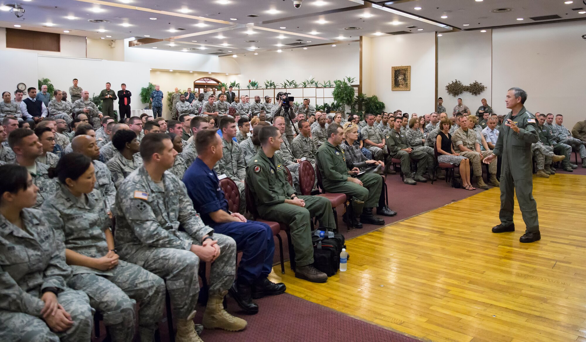 U.S. Pacific Command Commander Adm. Harry B. Harris Jr., addresses an audience of Team Yokota service members during a town hall meeting at Yokota Air Base, Japan, June 11, 2015. Harris visited Yokota during his first official visit to the Indo-Asia Pacific region, with stops in Korea and Japan. (U.S. Air Force photo by Osakabe Yasuo/Released)