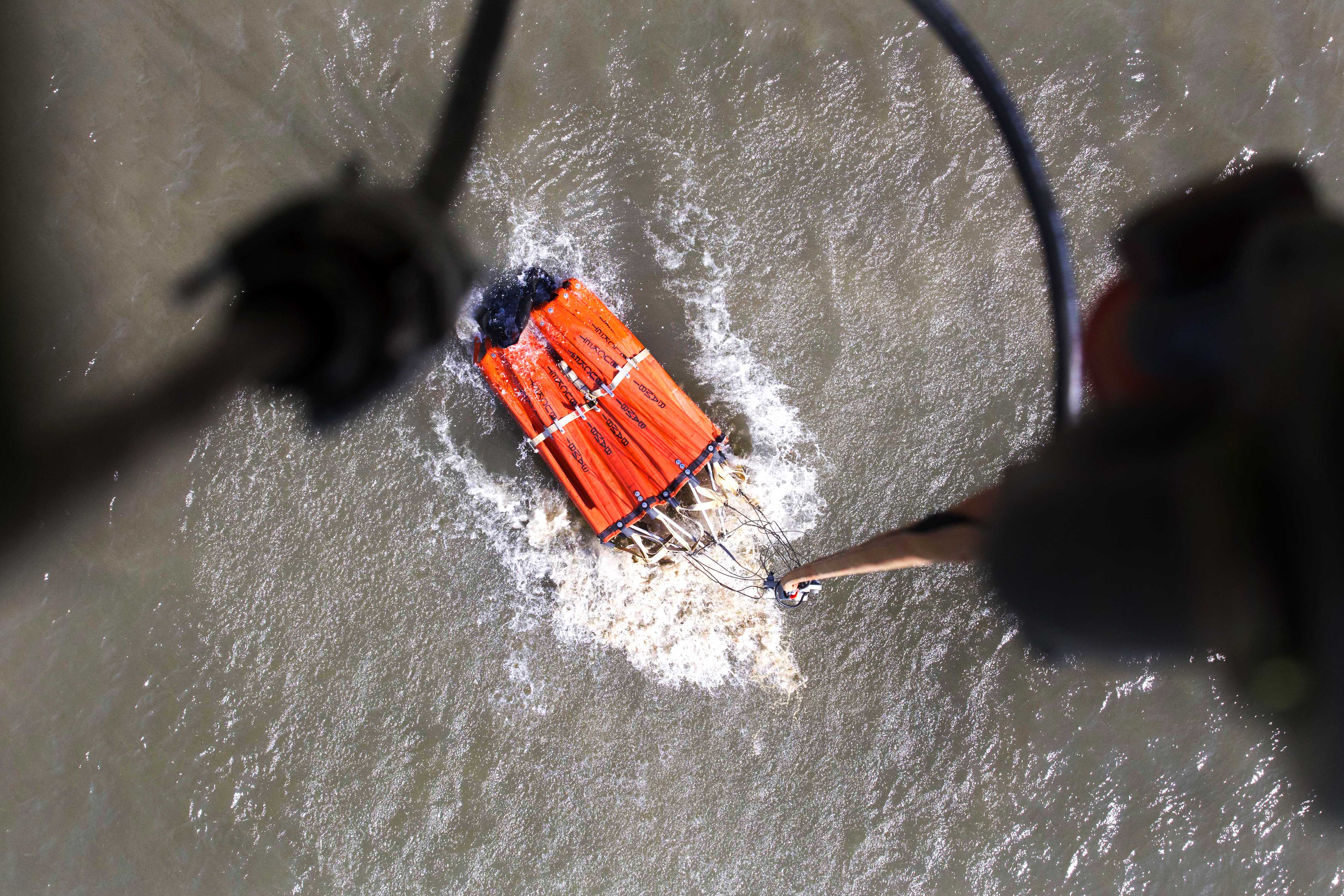 An Alaska Army National Guard UH60 Black Hawk helicopter refills a