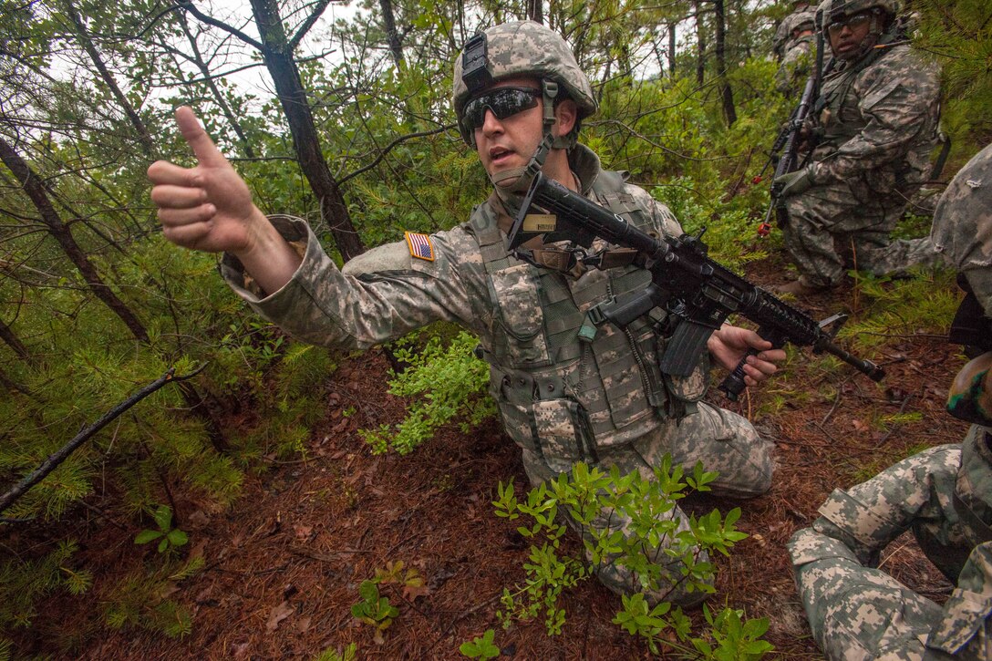 A New Jersey Army National Guardsman gives the thumbs up that his team ...