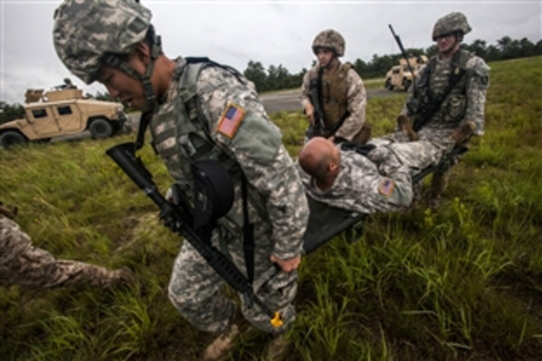 Soldiers evacuate a simulated wounded soldier during Operation Morning Coffee on Warren Grove Gunnery Range, N.J., June 18, 2015. The New Jersey Army and Air National Guard and the Marine Corps Reserve conduct the joint exercise.
