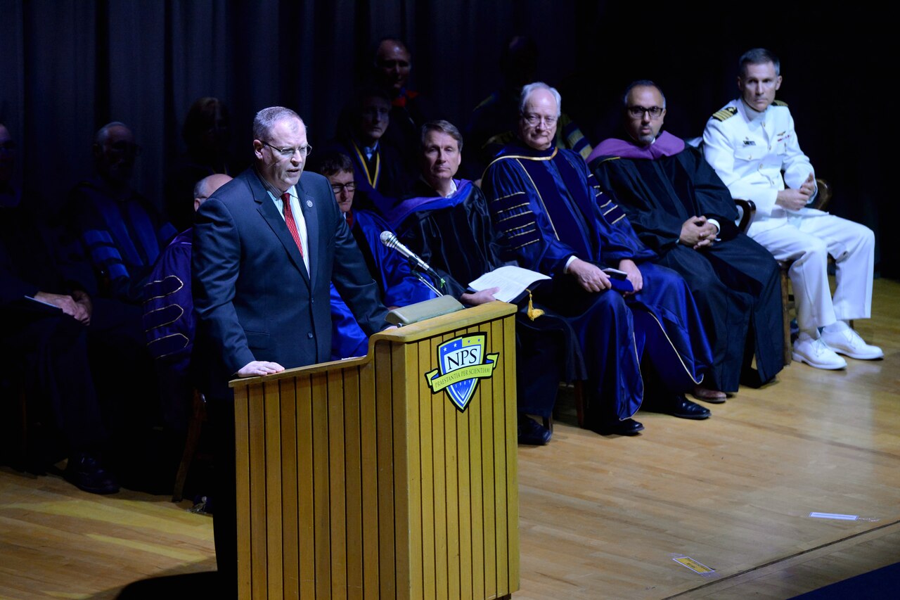 Deputy Defense Secretary Bob Work addresses the graduating class at the Naval Postgraduate School in Monterey, Calif., June 19, 2015. Work, who graduated from the school in 1990, said the American military must adapt to the changing world situation, and urged graduates to lead that change. DoD photo by U.S. Army Sgt. 1st Class Clydell Kinchen