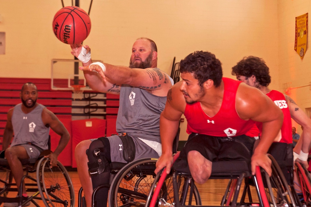 U.S. Army veteran Sgt. 1st Class Brian Lowen, a member of the U.S. Special Operations Command team, passes the ball during the 2015 Department of Defense Warrior Games Wheelchair Basketball competition on Marine Corps Base Quantico, Va., June 20, 2015. 