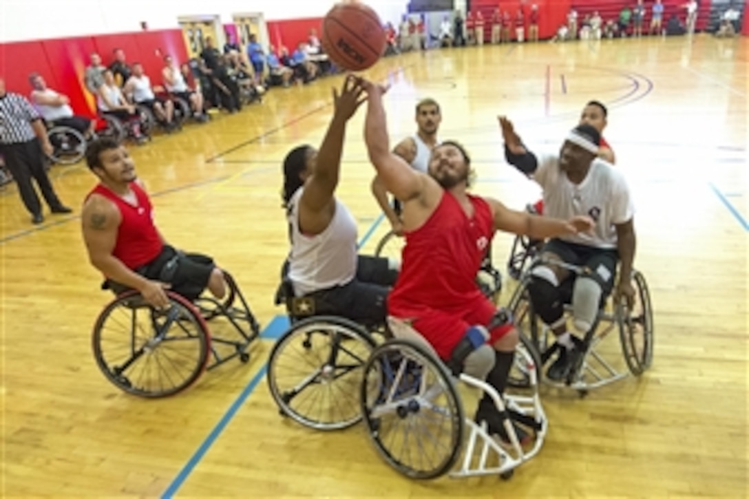 Teams Marine Corps and Army battle for a rebound during wheelchair basketball preliminary rounds for the 2015 Department of Defense Warrior Games on Marine Corps Base Quantico, Va. June 20, 2015.