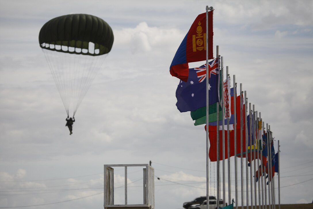 A Mongolian soldier with the Mongolian Armed Forces, Special Task Battalion 84, parachutes into the opening ceremonies of Exercise Khaan Quest 2015 at Five Hills Training Area in Tavantolgoi, Mongolia, June 15, 2015. Khaan Quest is a regularly scheduled, multinational exercise hosted annually by Mongolian Armed Forces and co-sponsored by U.S. Army, Pacific, and U.S. Marine Corps Forces, Pacific. KQ15 is the latest in a continuing series of exercises designed to promote regional peace and security. This year marks the 13th iteration of this training event.
