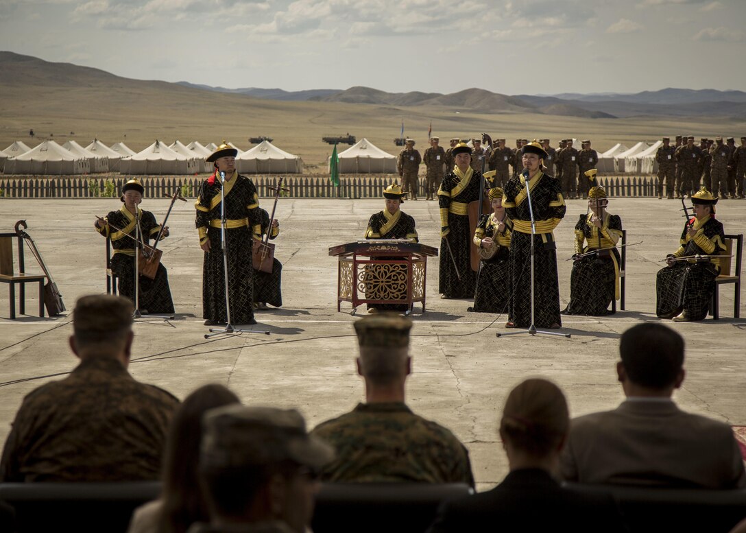The Mongolian Military Dance and Song Ensemble performs traditional Mongolian folk music for a panel of distinguished visitors of participating nations during the opening ceremonies of Khaan Quest 2015, in Tavantolgoi, Mongolia, June 20, 2015. Khaan Quest is a regularly scheduled, multinational exercise hosted annually by Mongolian Armed Forces and co-sponsored by U.S. Army, Pacific, and U.S. Marine Corps Forces, Pacific. KQ15 is the latest in a continuing series of exercises designed to promote regional peace and security. This year marks the 13th iteration of this training event. 