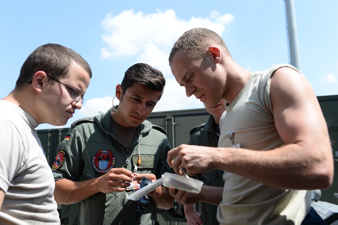 U.S. Air Force Airmen work with German Air Force Airmen to locate a part to fix a refueling pod on a German tanker aircraft June 18, 2015, at 3rd Main Jet Base, Turkey. Anatolian Eagle was a two-week flying training exercise involving U.S. Air Forces in Europe units and multiple NATO partners. (U.S. Air Force photo by Tech. Sgt. Eric Burks/Released)