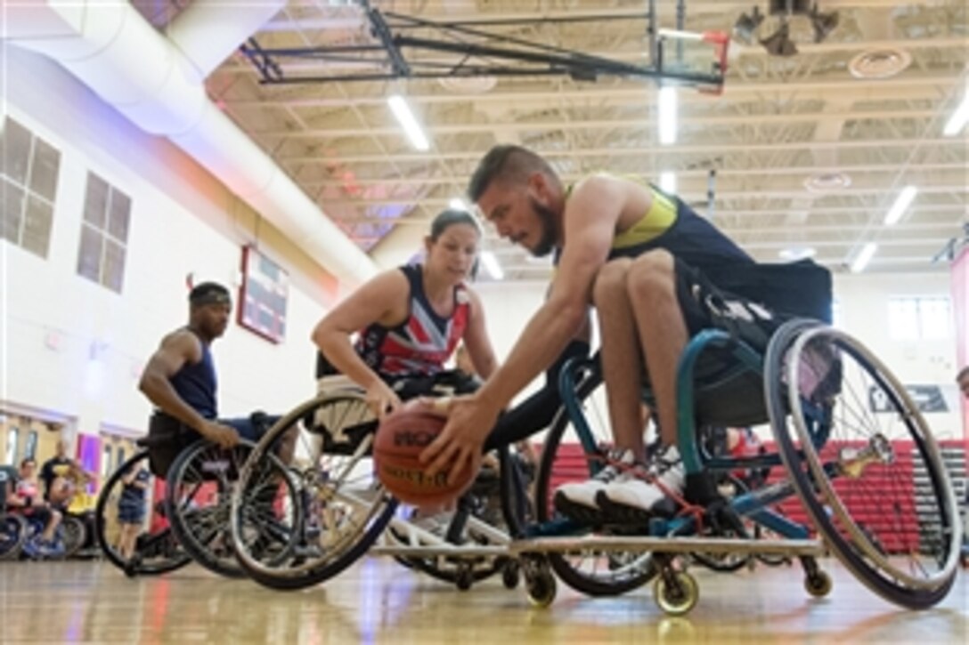 Team Navy’s Daniel Crossley picks up a rebound during wheelchair basketball preliminary rounds during the 2015 Department of Defense Warrior Games on Marine Corps Base Quantico, Va. June 20, 2015. 