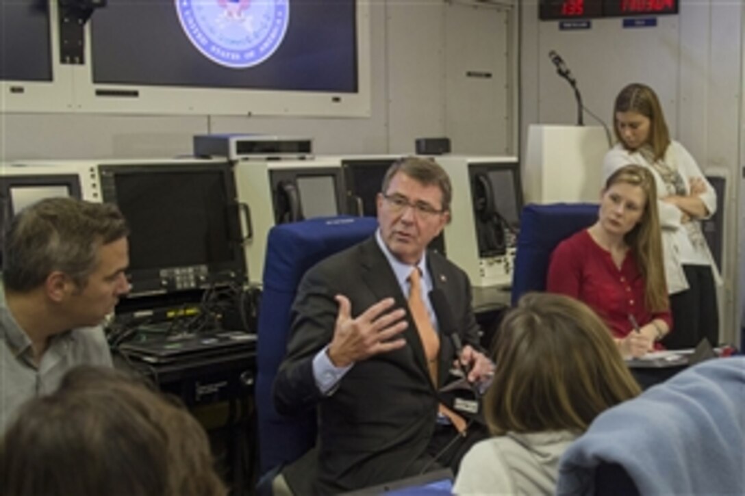 U.S. Defense Secretary Ash Carter talks with news reporters aboard an aircraft en route to Berlin, June 21, 2015. Carter plans to meet with European defense ministers and participate in his first NATO ministerial as defense secretary during the trip to Germany, Estonia and Belgium. 