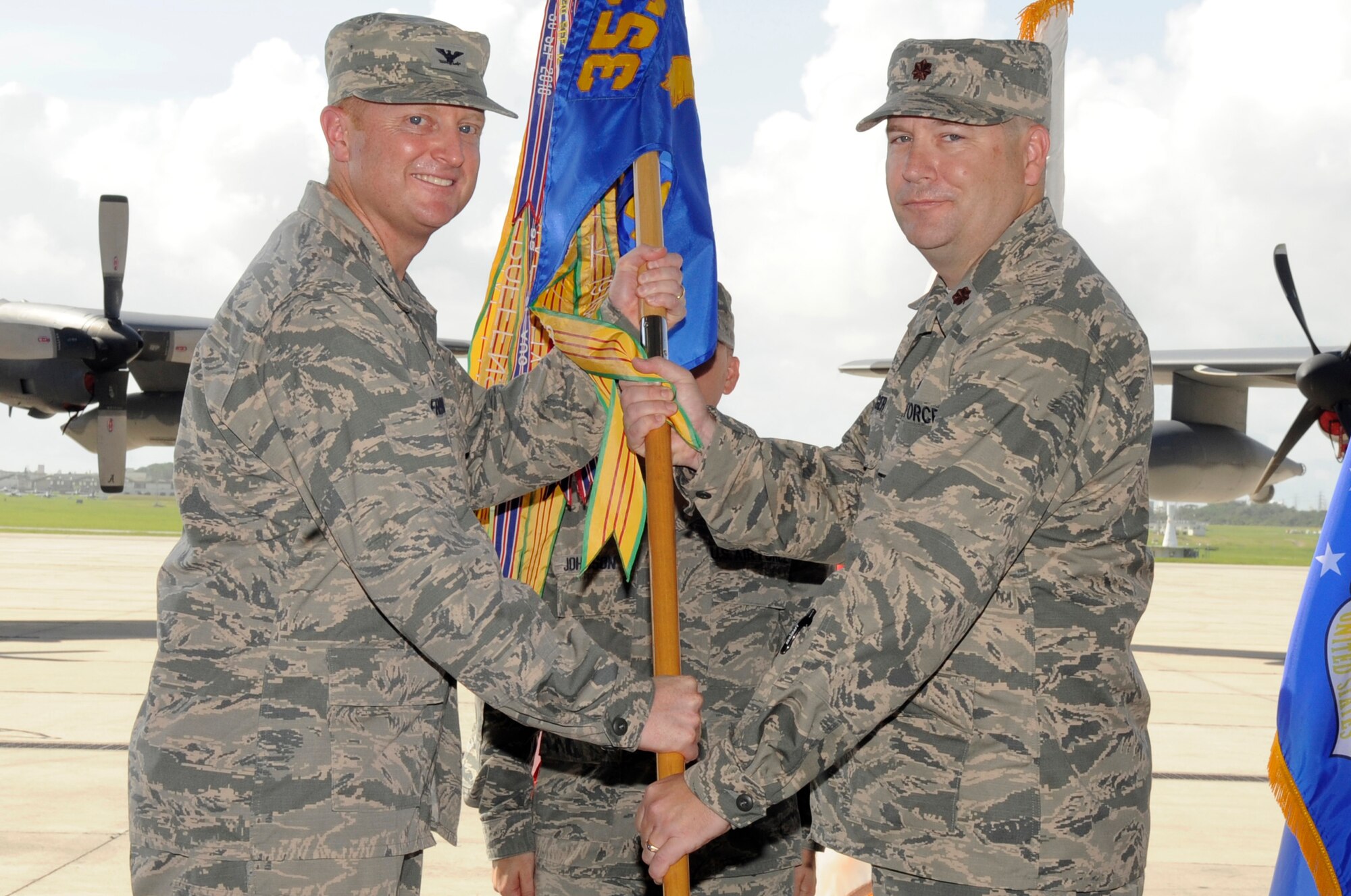 U.S. Air Force Maj. Aaron Yager, newly appointed commander of the 353rd Special Operations Maintenance Squadron, accepts the guidon from Col. William Freeman, 353rd Special Operations Group commander, during a change of command ceremony on Kadena Air Base, Japan, June 19, 2015. Yager comes from Headquarters United States Special Operations Command, MacDill Air Force Base, Florida, where he served as director fixed wing logistics and joint acquisitions team lead, directorate of logistics. (U.S. Air Force photo by Staff Sgt. Marcus Morris)